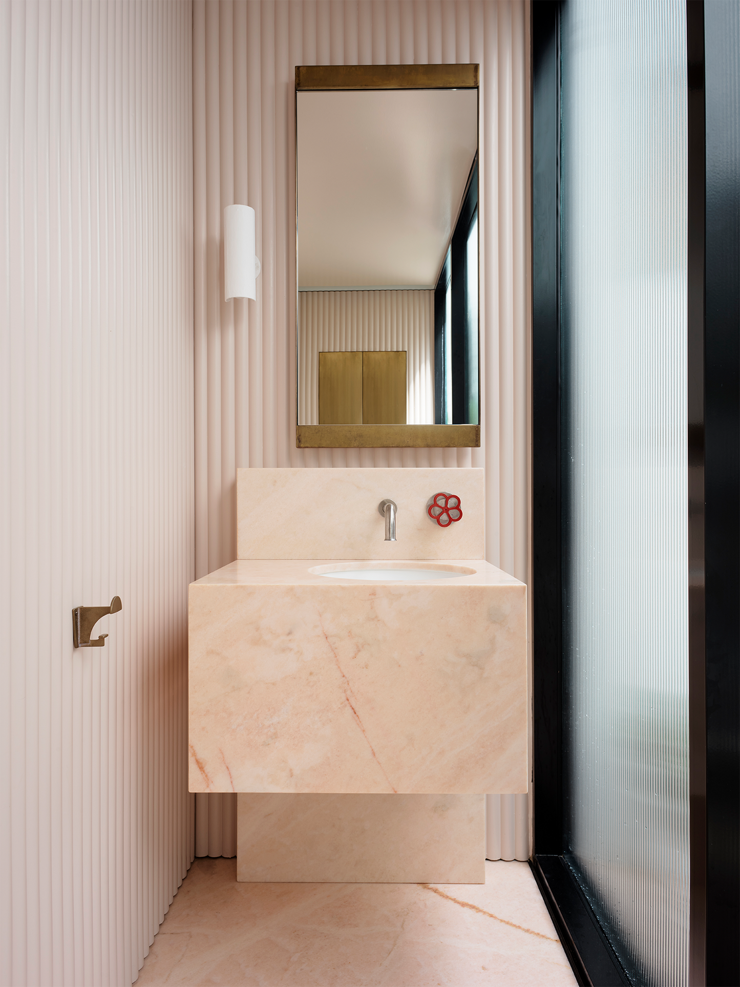 Toscana marble sink in soft pink natural stone with integrated basin in a modern minimalist bathroom