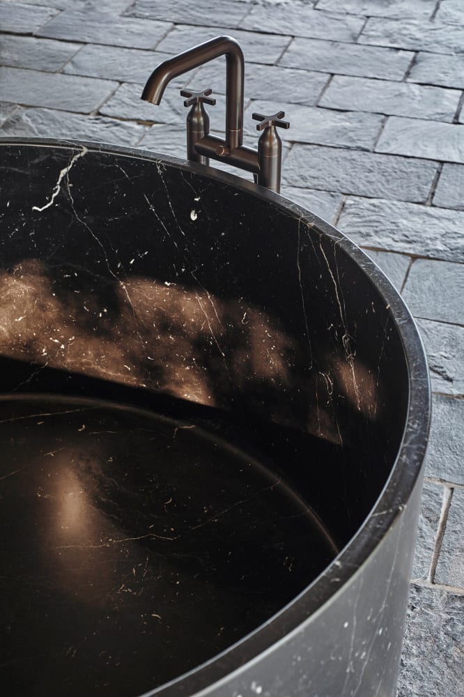 Anfora round black marble freestanding stone bathtub interior detail with natural marble veining