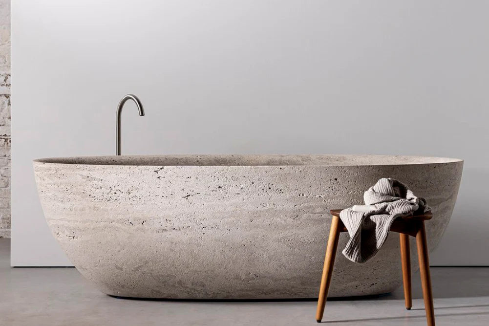 Anfora round travertine stone freestanding bathtub in minimalist luxury bathroom