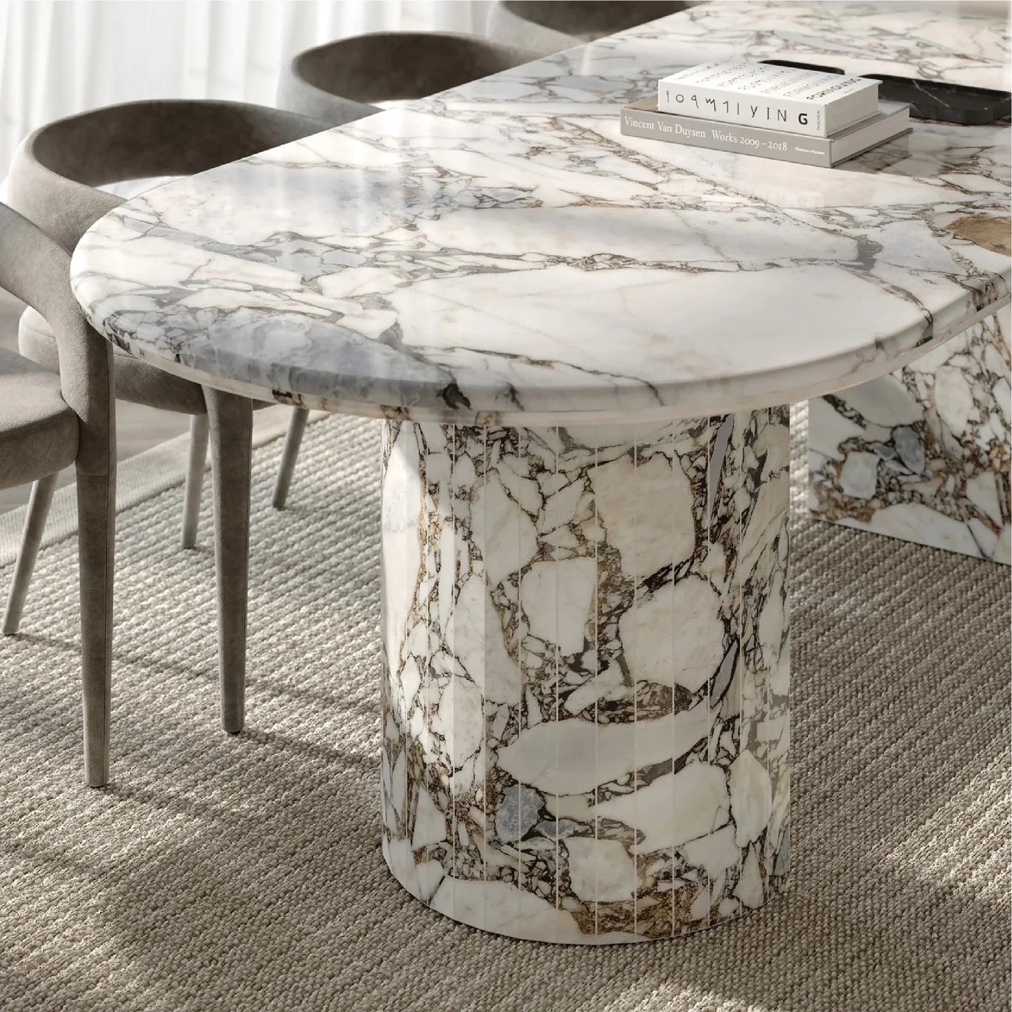 Detail of Anzio Calacatta Viola marble dining table showing oval stone top and sculptural marble base