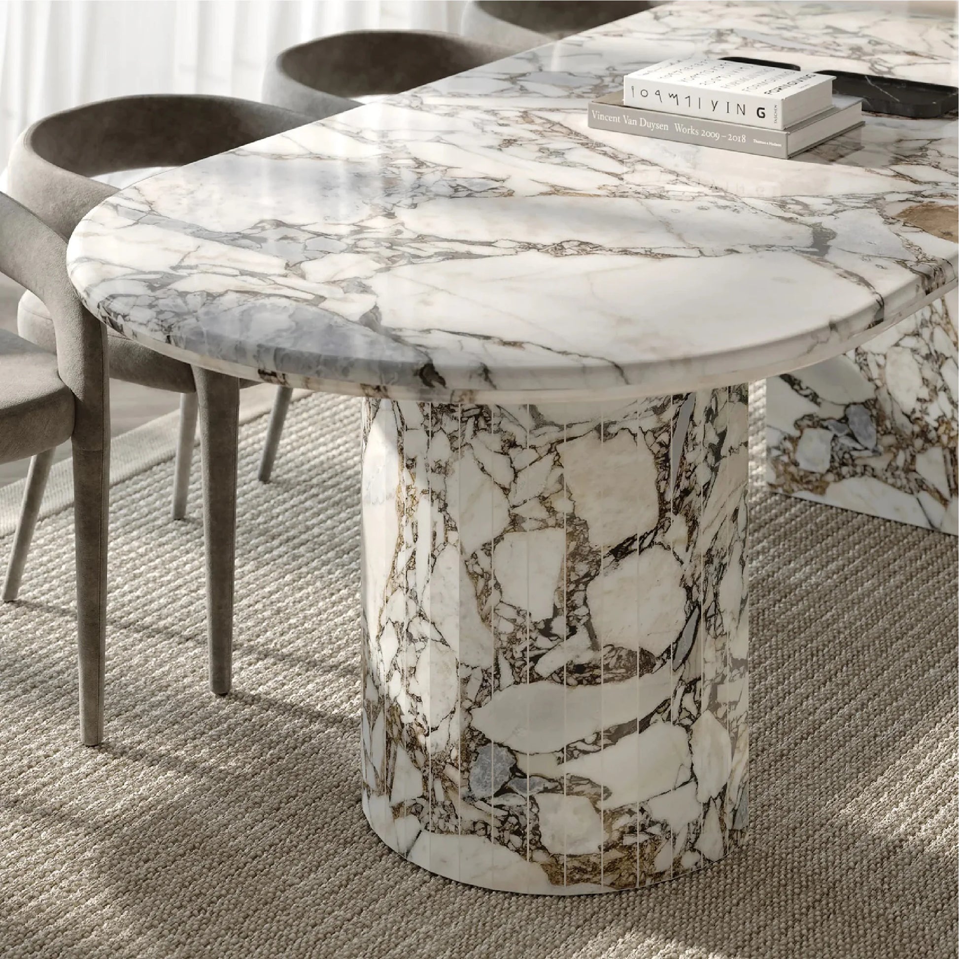 Detail of Anzio Calacatta Viola marble dining table showing oval stone top and sculptural marble base