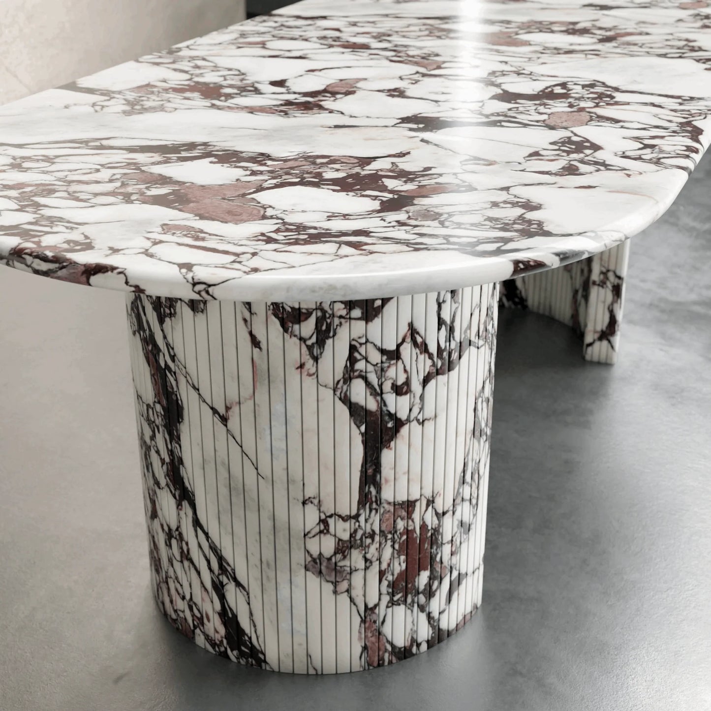Detail of Anzio Calacatta Viola marble dining table showing red and white natural stone veining