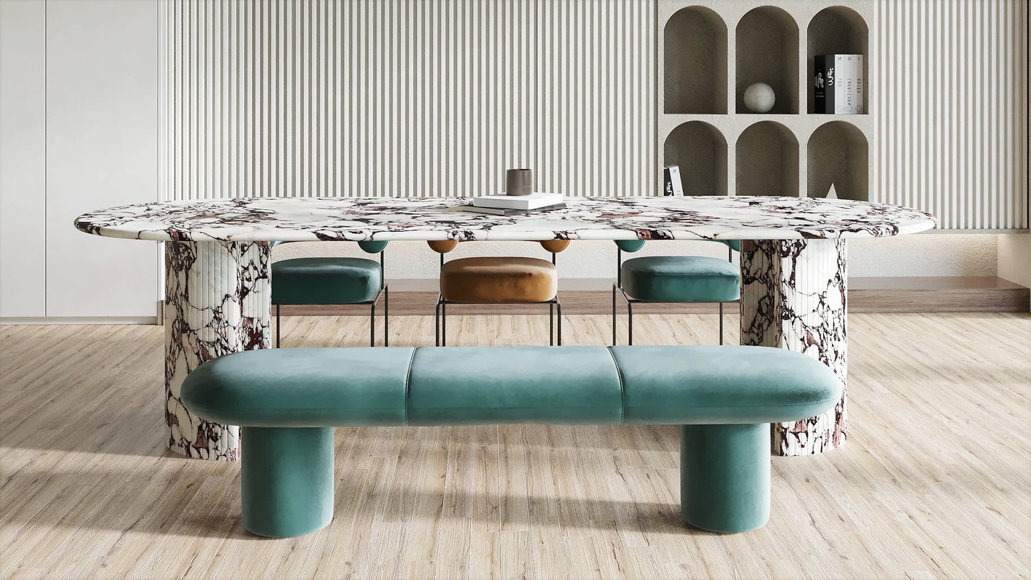 Anzio Calacatta Viola marble dining table with sculptural stone base styled with upholstered bench and dining chairs