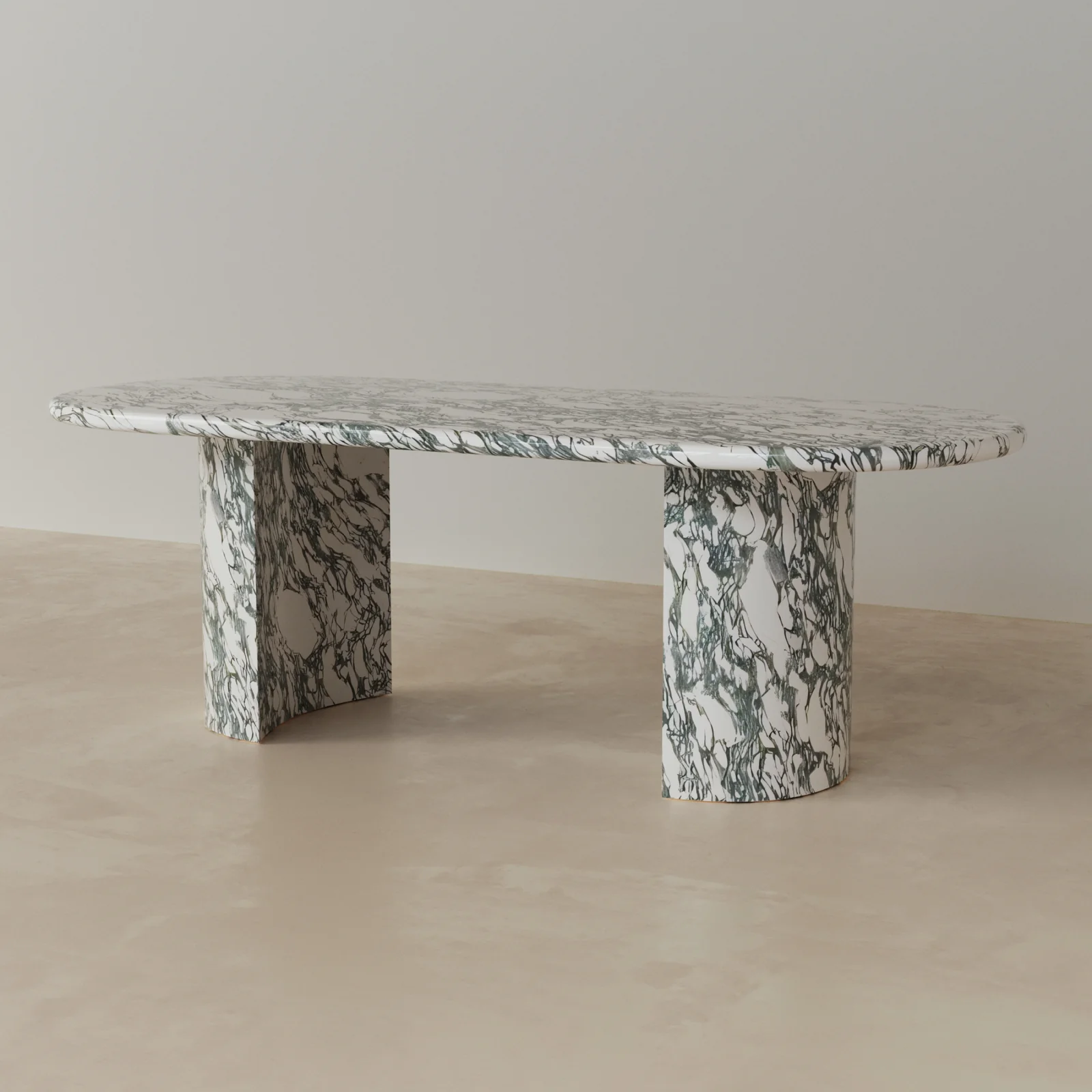 Side view of Anzio oval dining table in green marble with sculptural stone pedestal base