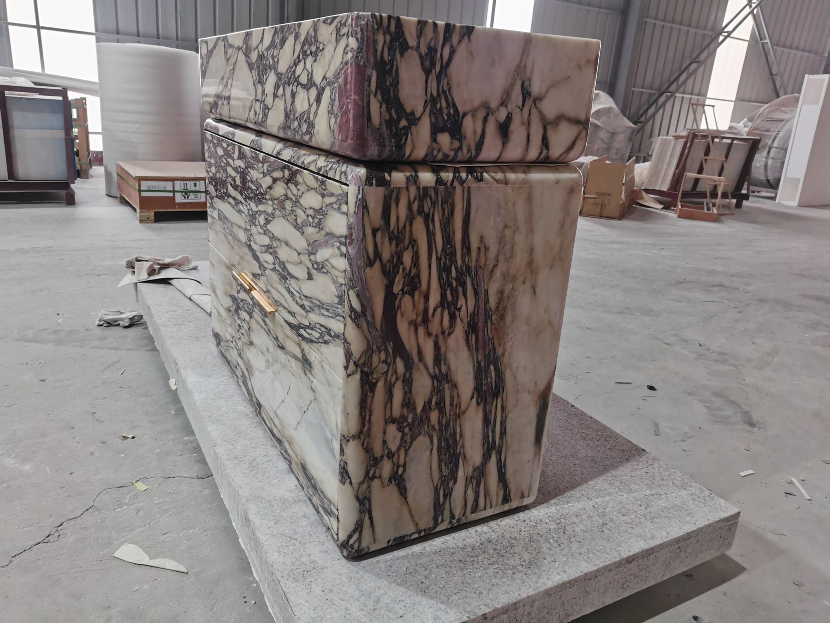 Calacatta Viola marble vanity handcrafted in workshop showing natural stone veining and form
