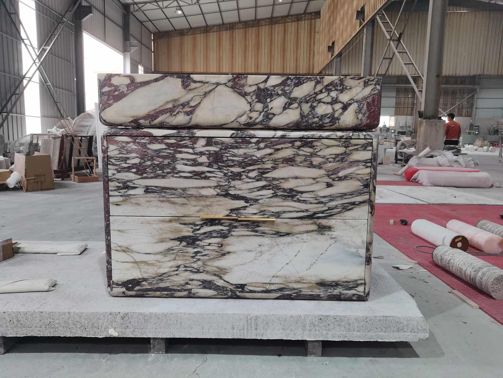 Handcrafted marble vanity in production workshop showing natural stone craftsmanship
