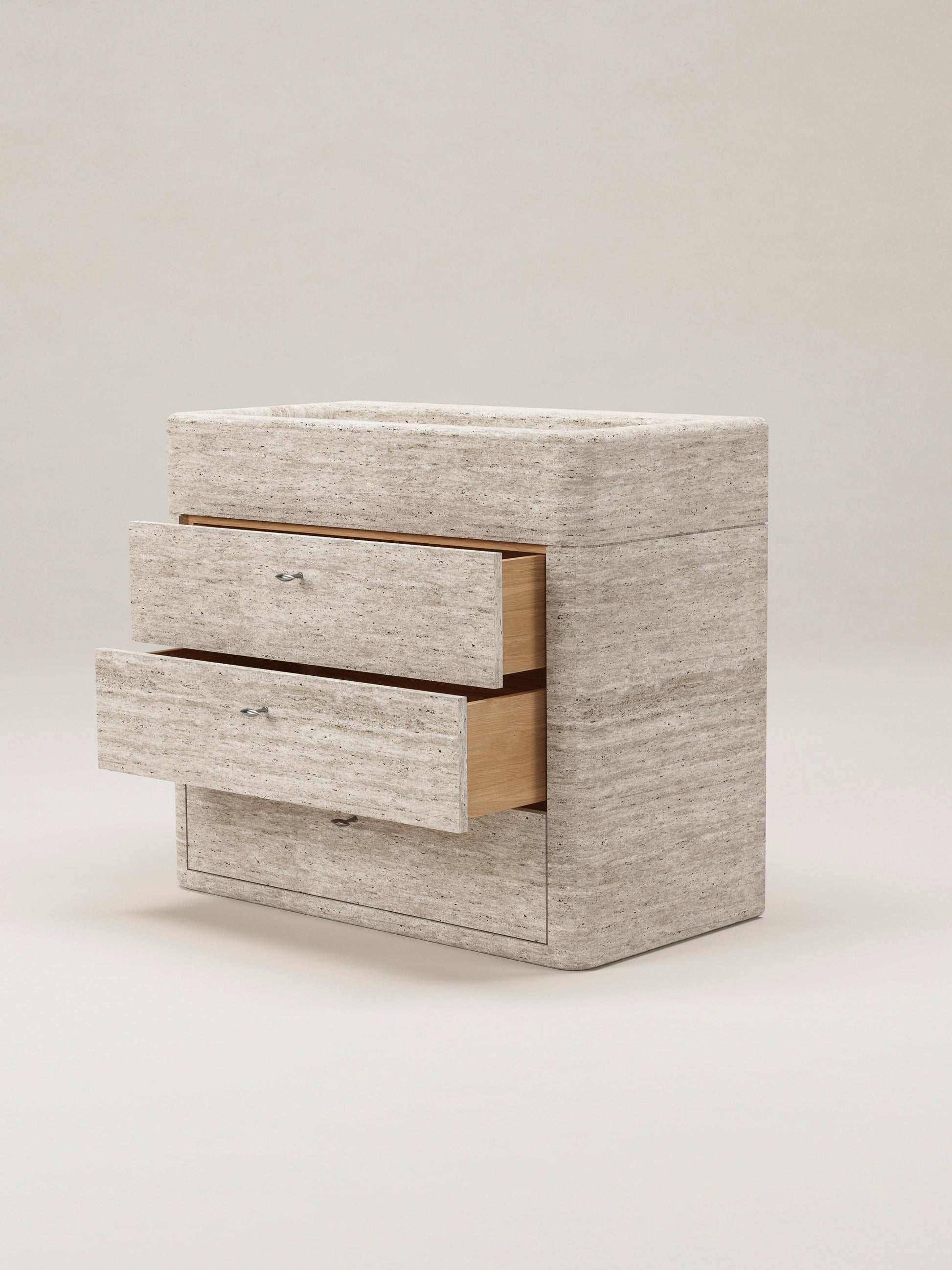 Travertine stone bathroom vanity with open drawers showing storage and natural wood interior