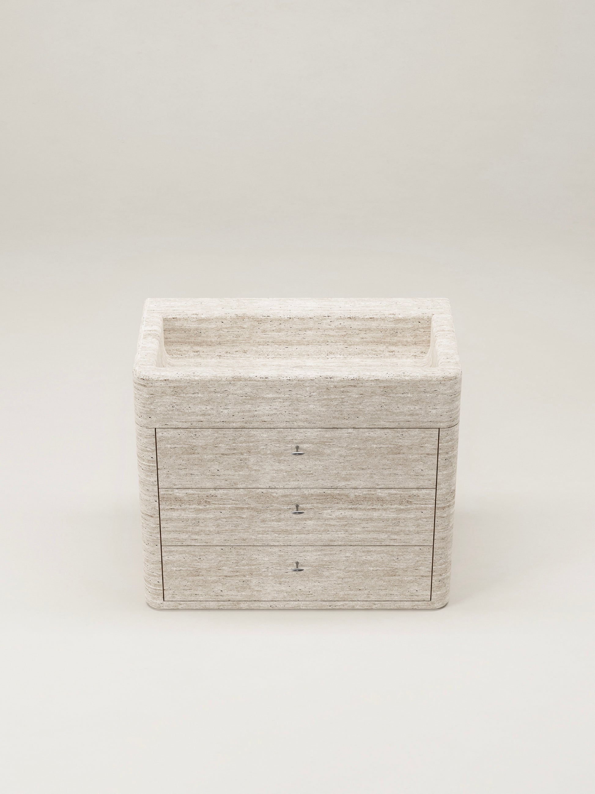 Travertine stone bathroom vanity with drawers and integrated sink on white background