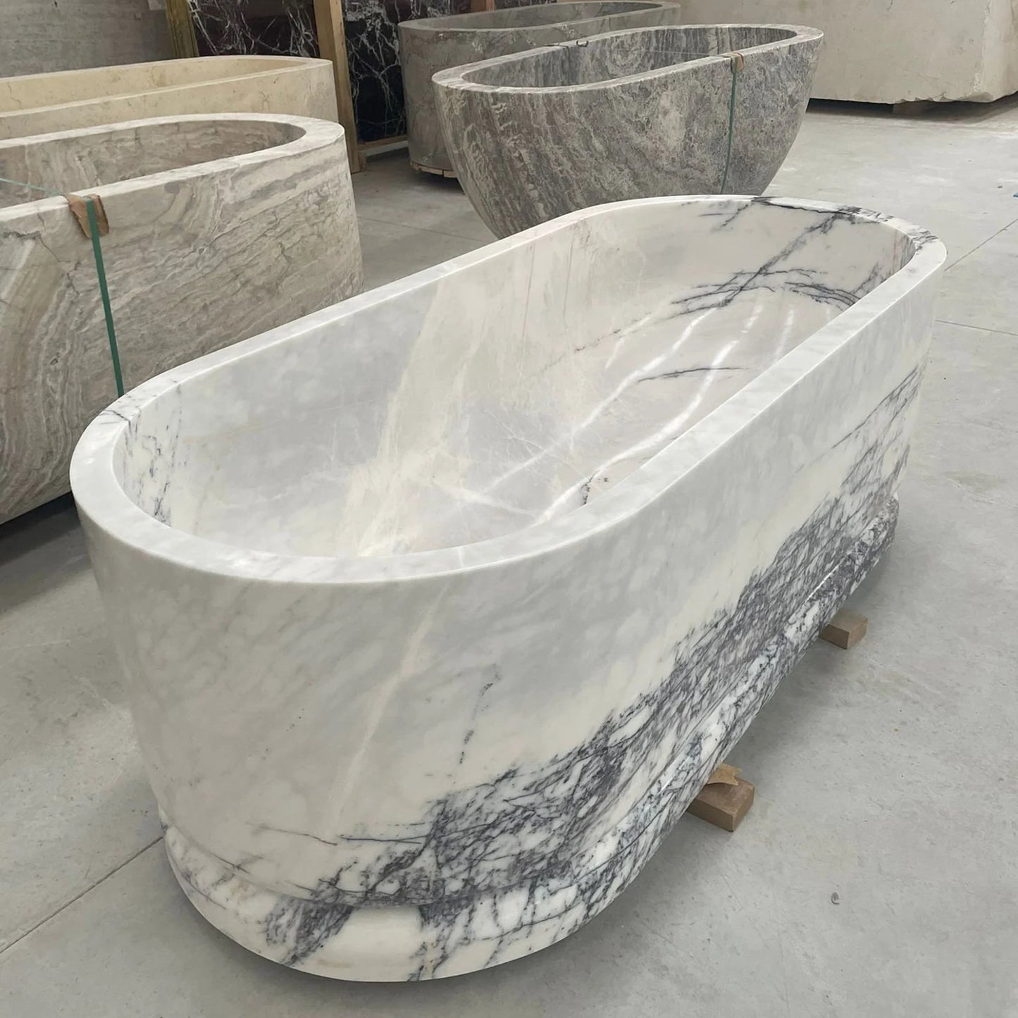 Calacatta marble freestanding bathtub in stone workshop by Eden Stone Designs