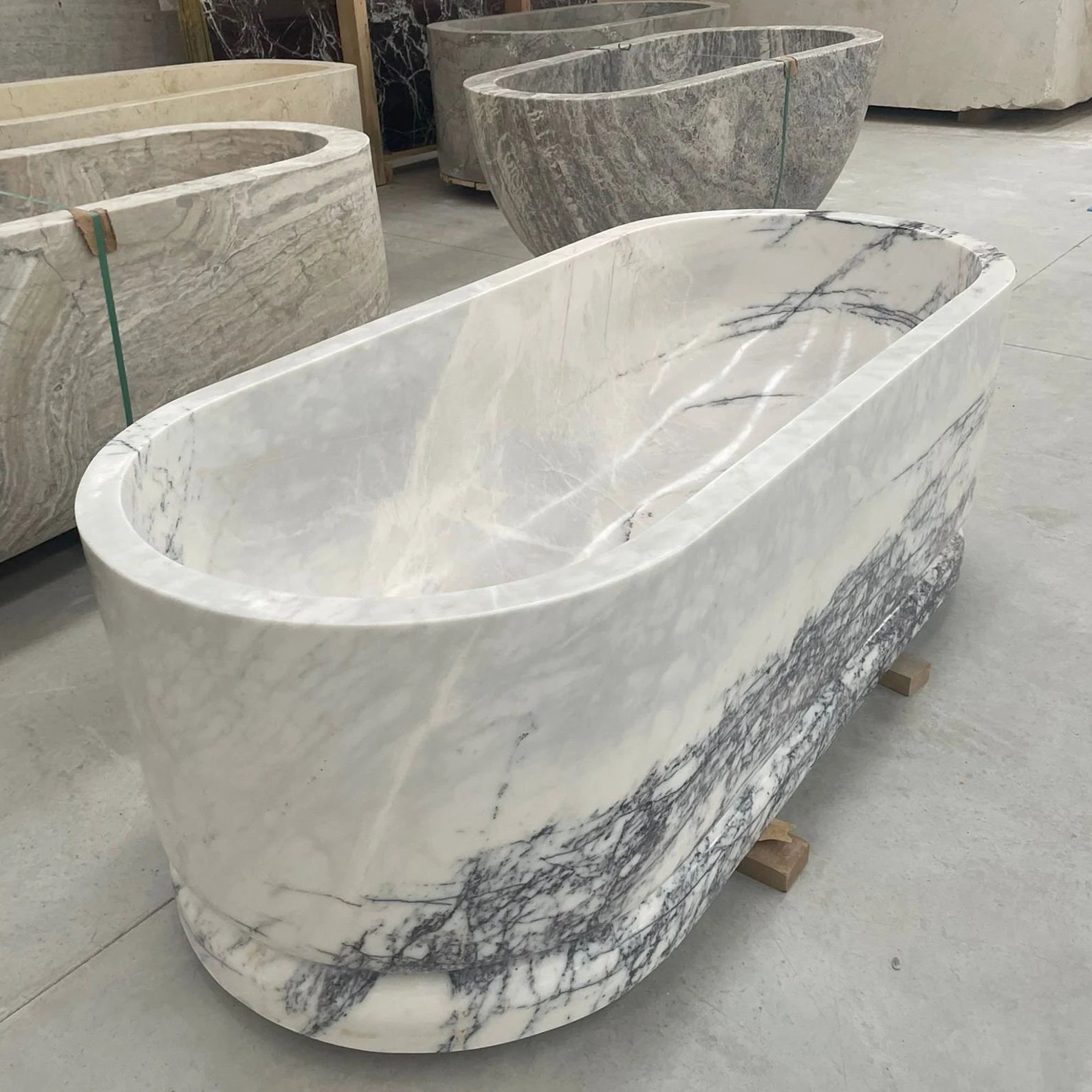 Calacatta marble freestanding bathtub in stone workshop by Eden Stone Designs
