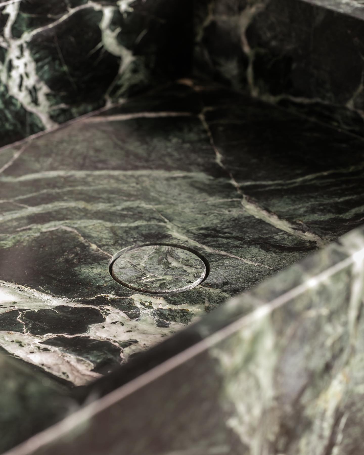 Florence marble vanity basin detail showing integrated drain carved from green natural stone