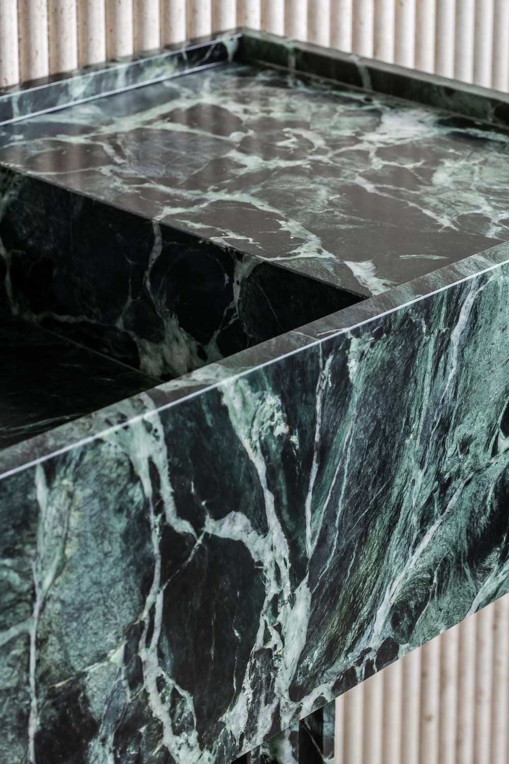 Florence marble vanity edge detail showing thick green natural stone with continuous veining