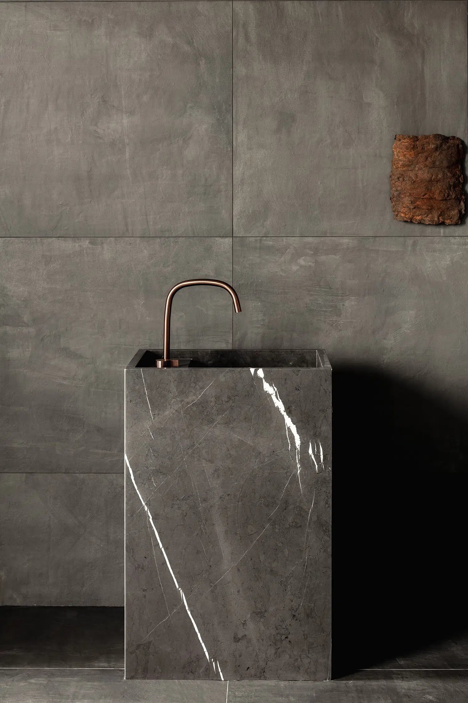Genoa marble vanity in grey natural stone with subtle white veining in a minimalist bathroom setting