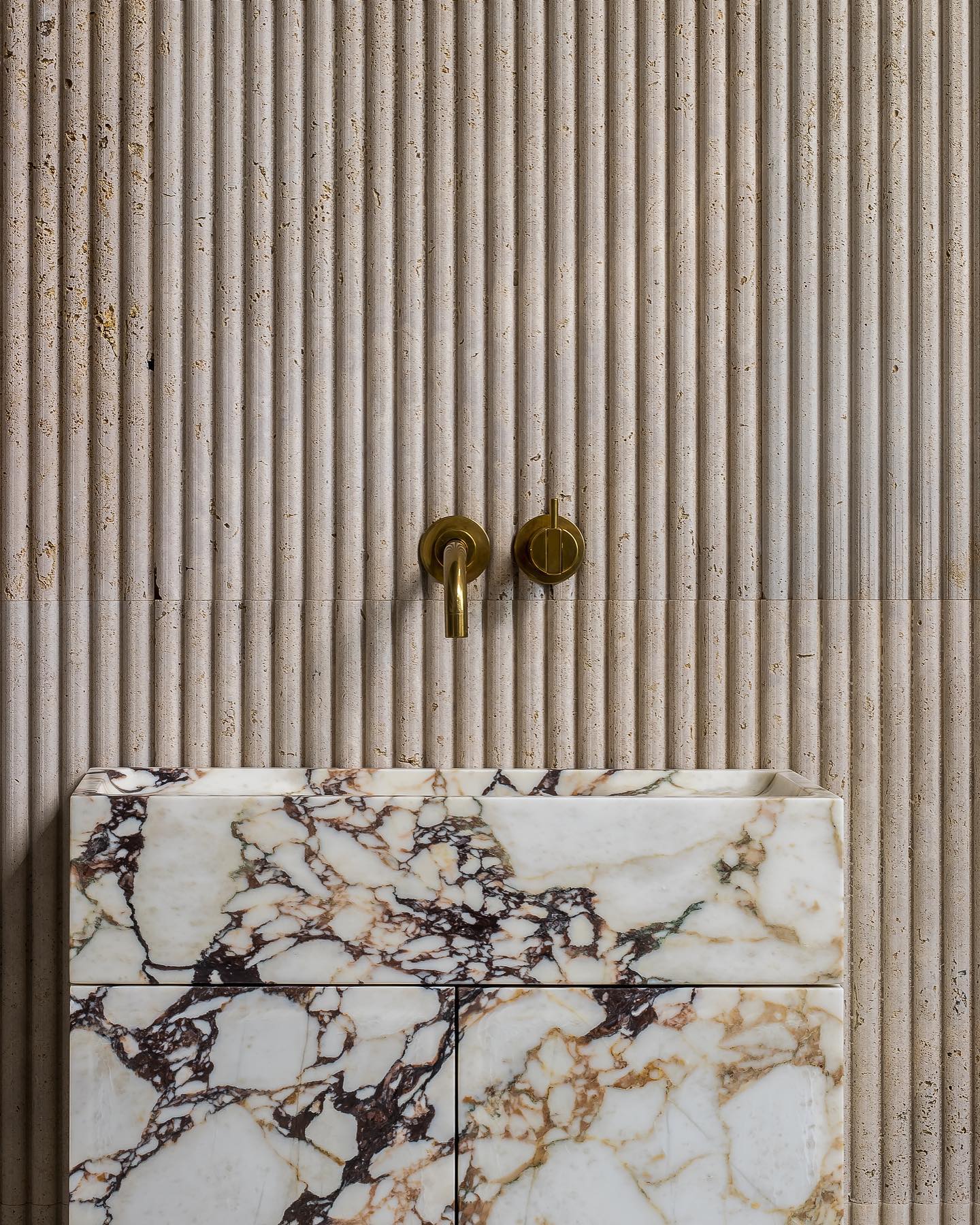 Close-up of Calacatta Viola marble vanity with bold veining and natural stone texture