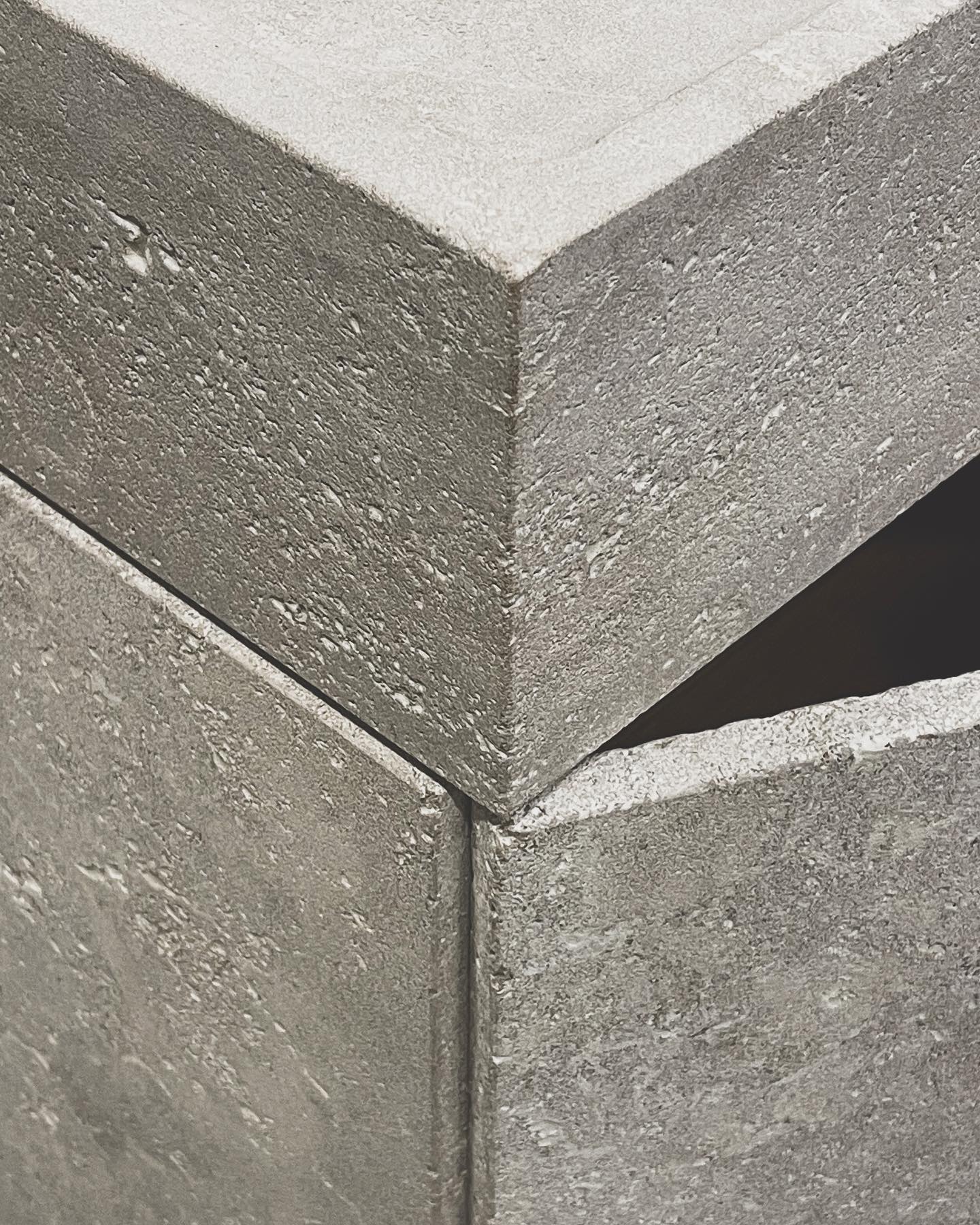 Natural stone vanity corner detail with raw texture and porous surface finish