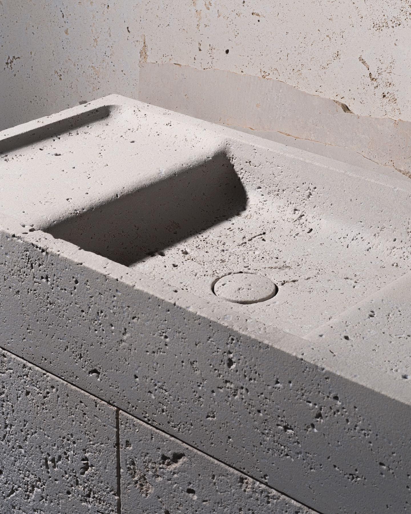 Natural stone vanity sink with raw textured surface and handcrafted finish detail