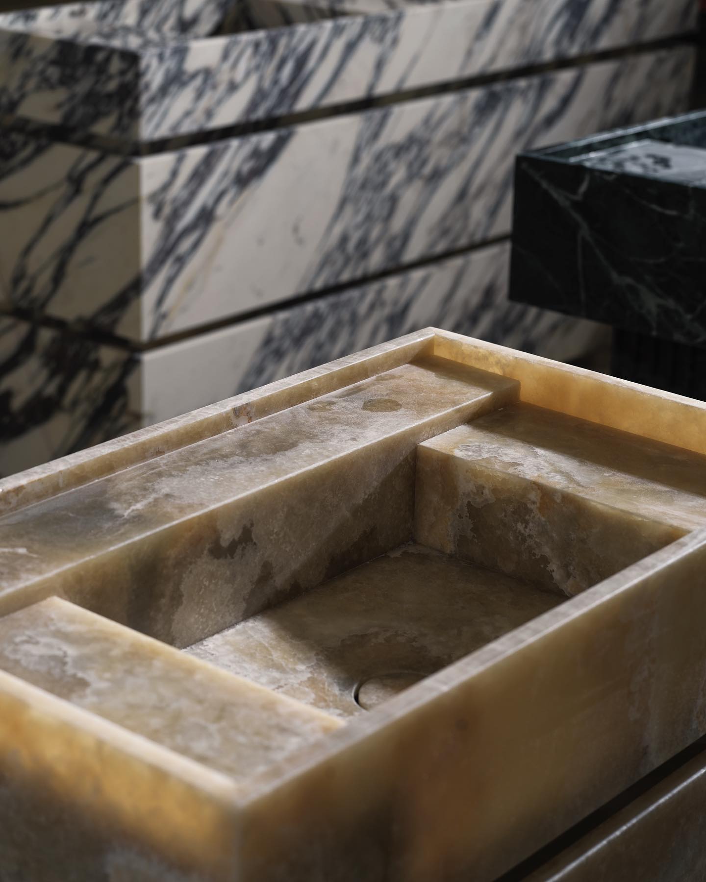 Luxury stone vanity sink in warm tones with marble background and refined design detail