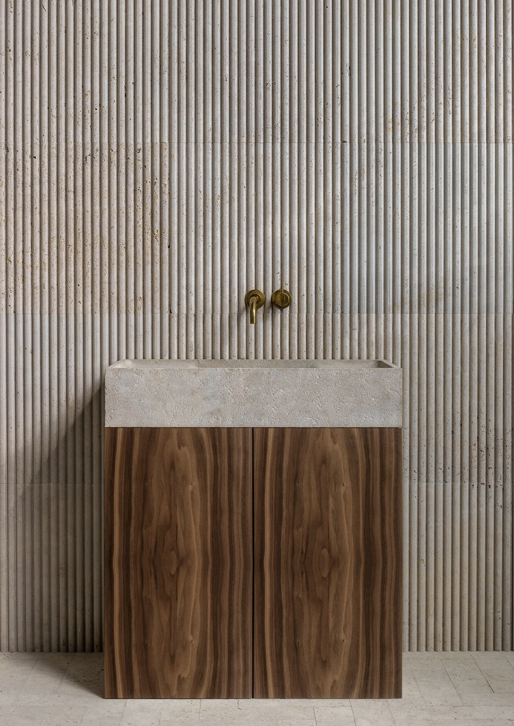 Teak wood bathroom vanity with natural marble sink and fluted stone wall background
