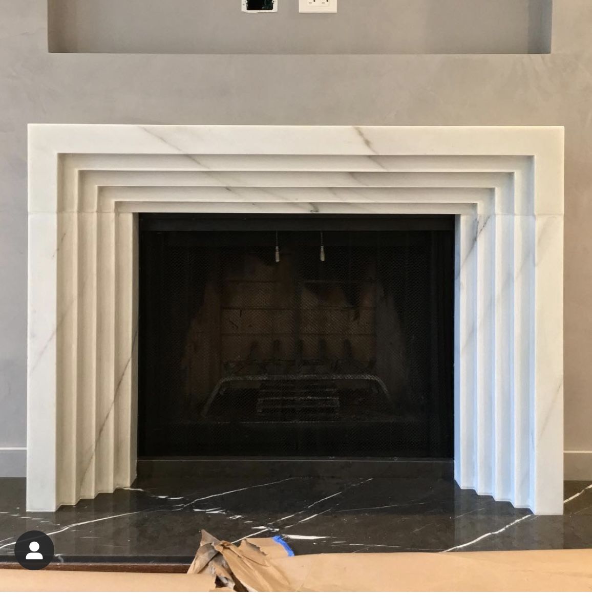 Matera marble fireplace surround installed in modern interior luxury stone fireplace