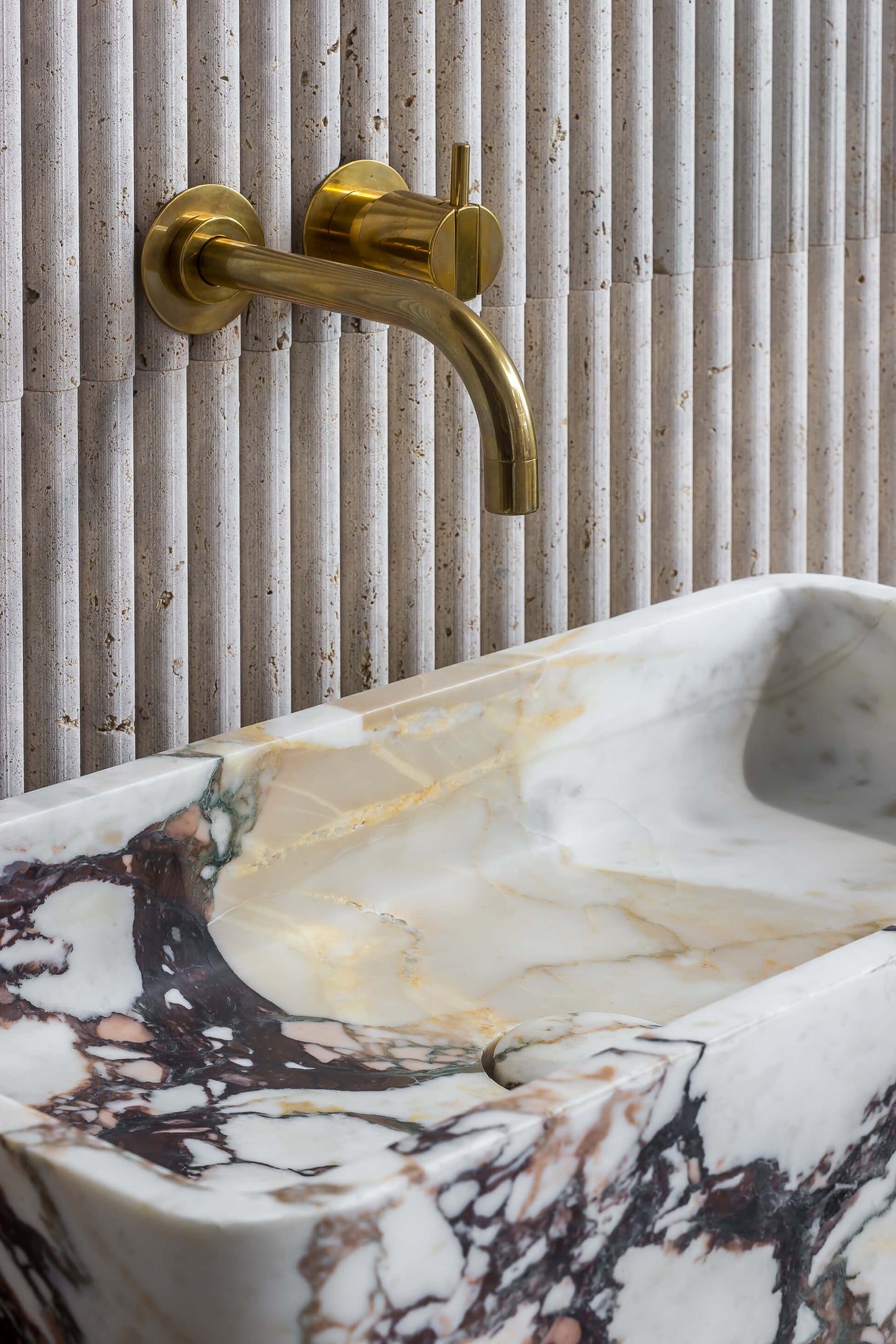 luxury marble sink detail Milan design close up Calacatta Viola stone basin with brass faucet Eden Stone Designs