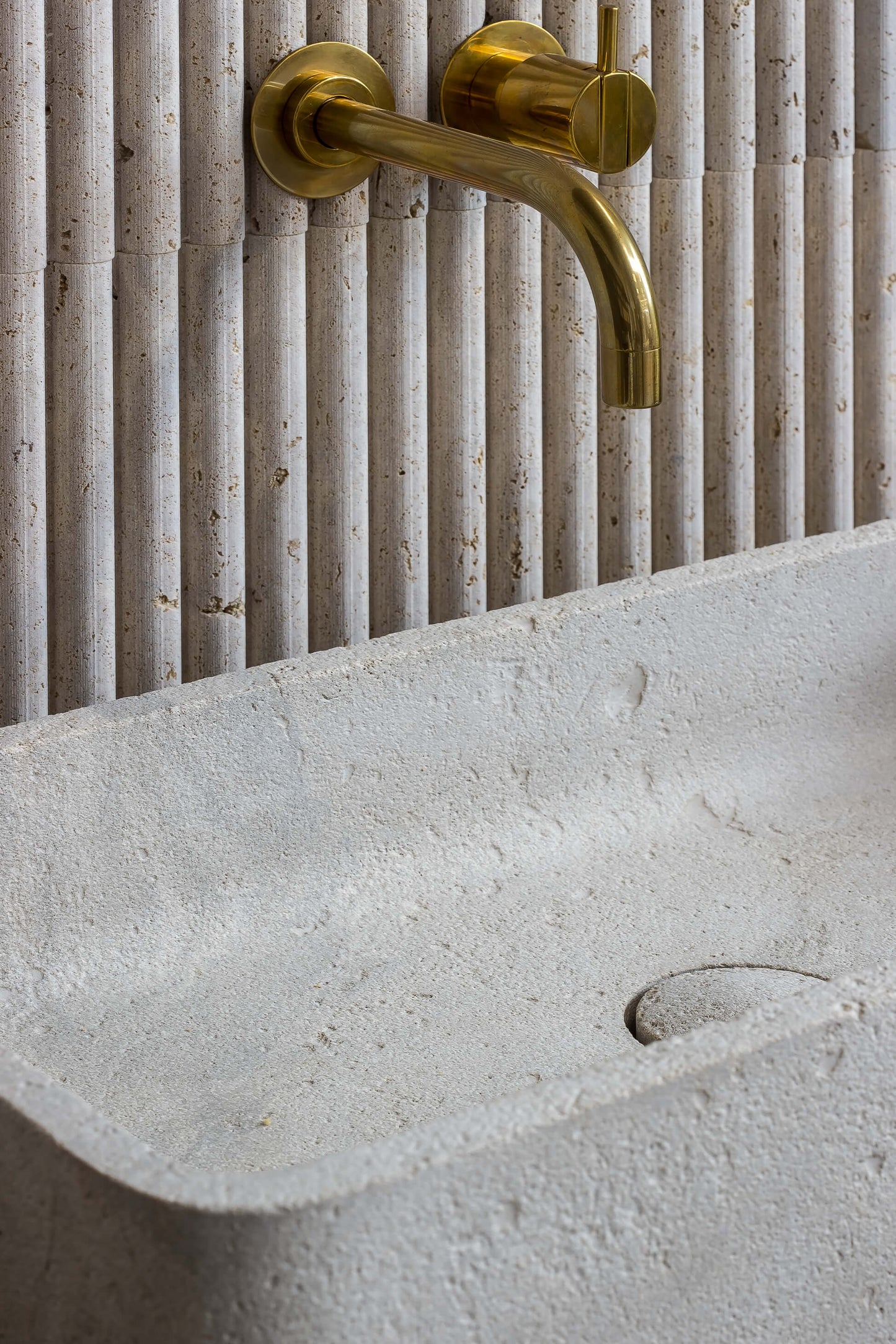 luxury travertine sink detail Milan design natural stone basin raw texture bathroom Eden Stone Designs