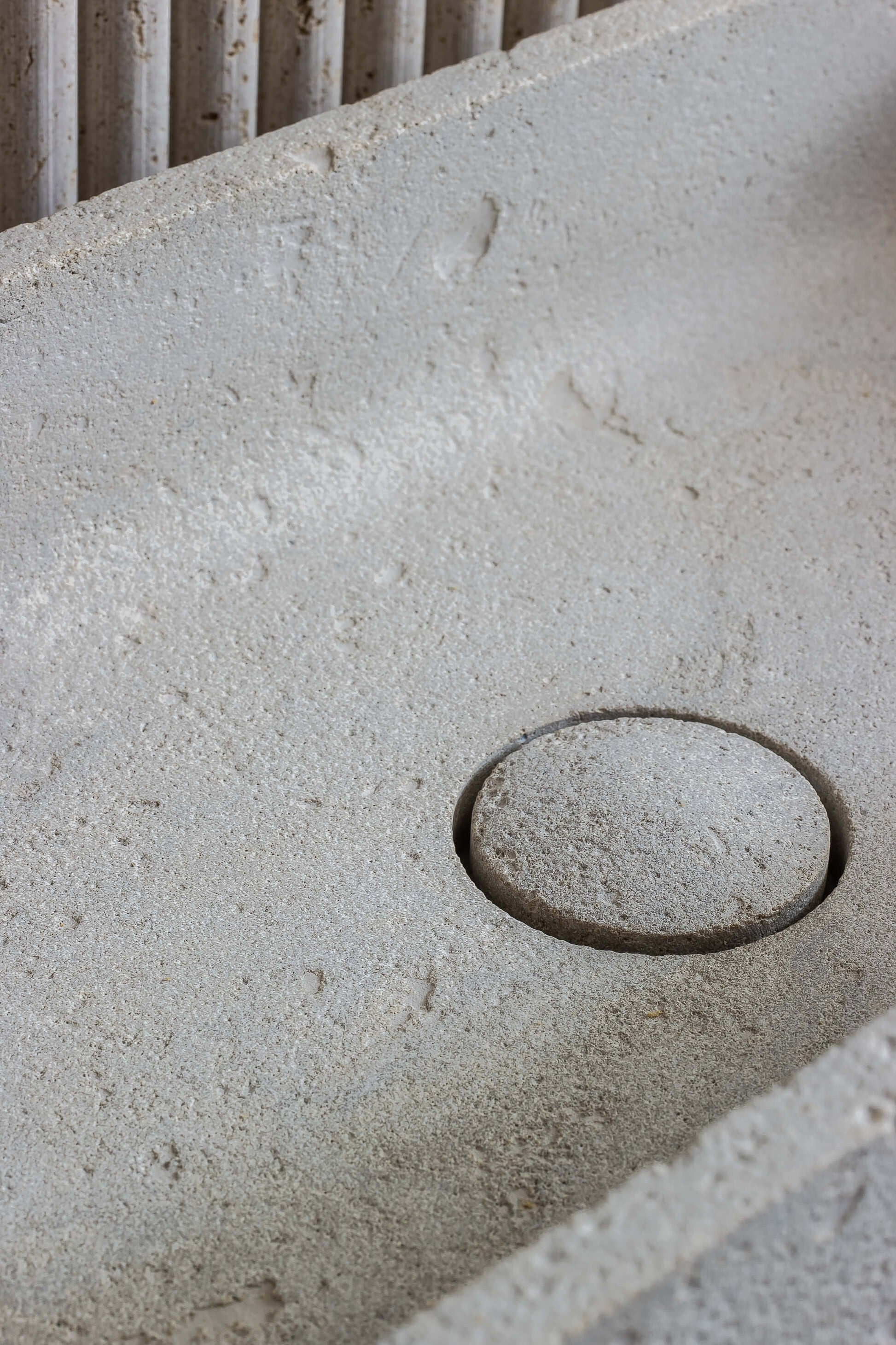 luxury travertine sink drain detail Milan design integrated stone basin custom bathroom Eden Stone Designs