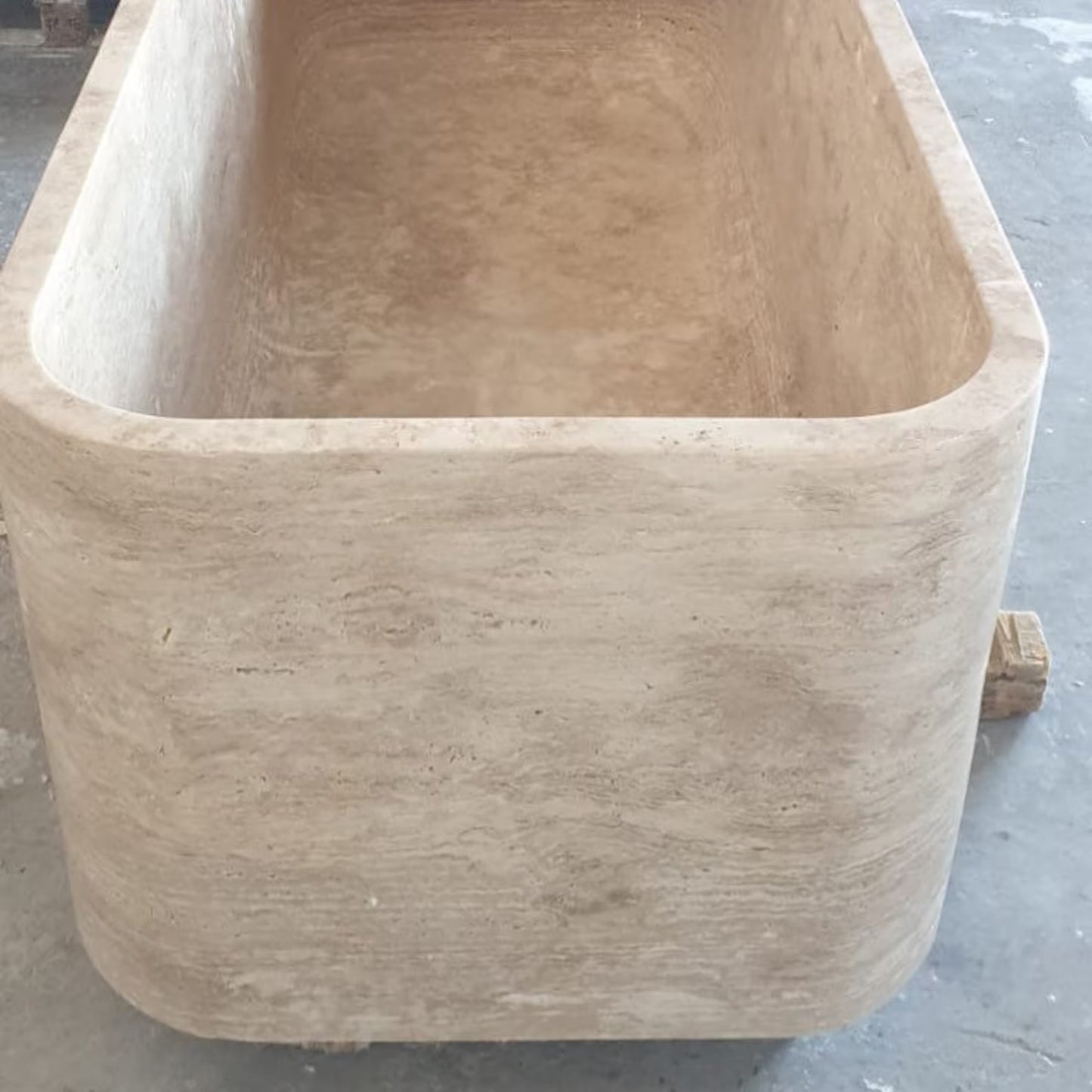 Mirlo travertine freestanding stone bathtub front view carved from a single block of natural stone