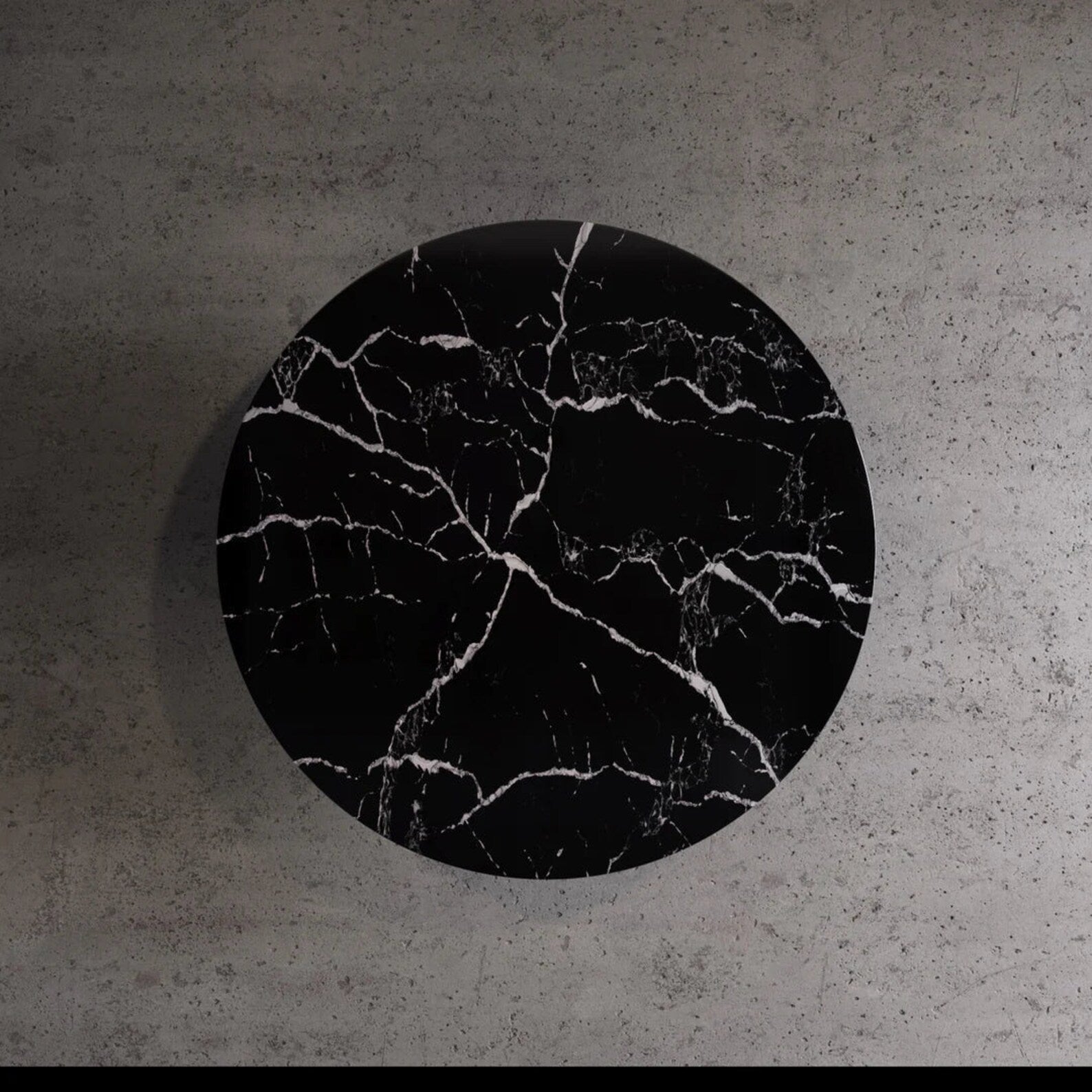 Top view of Palermo round black marble dining table with natural white veining by Eden Stone Designs