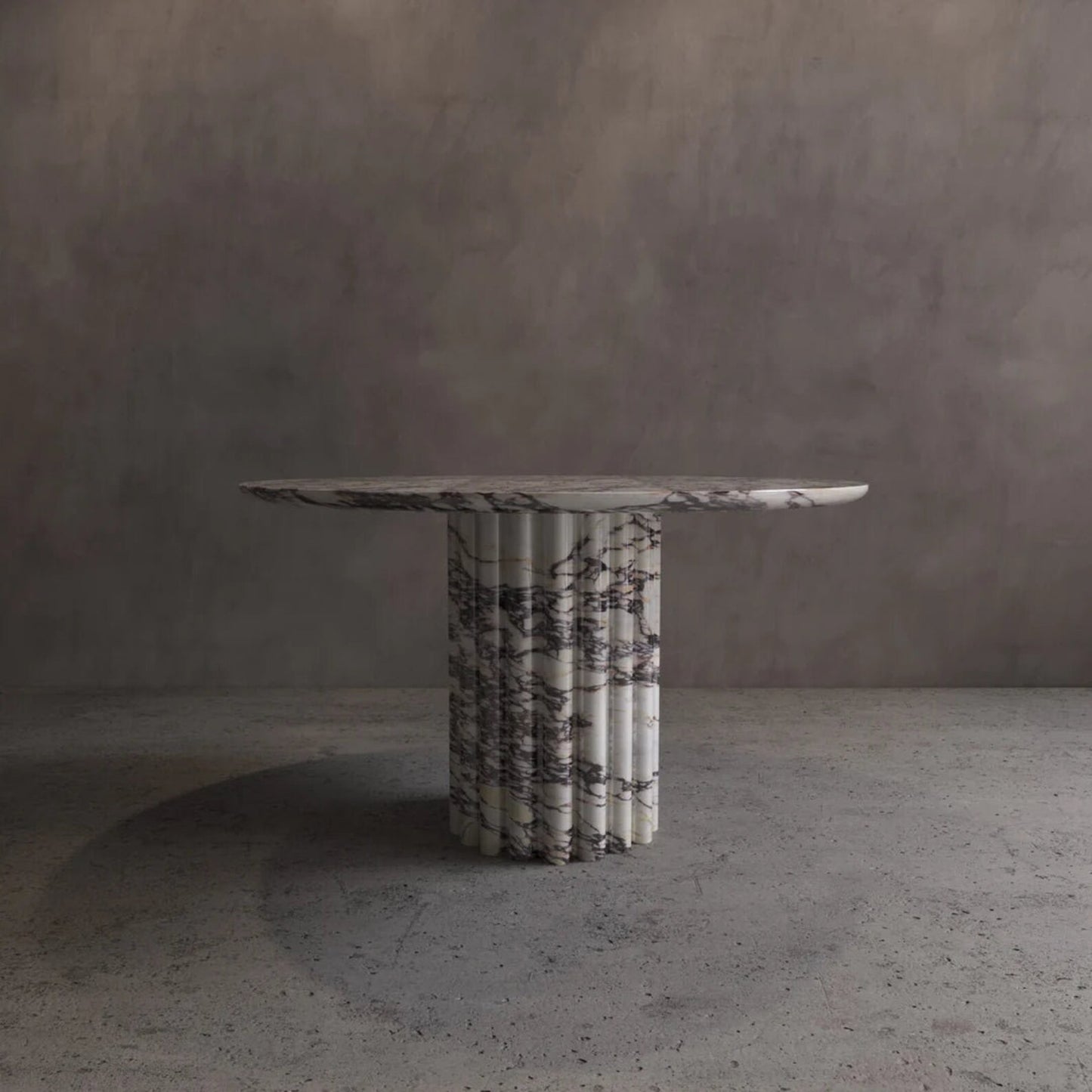 Palermo round marble dining table with sculptural fluted marble pedestal and natural veining by Eden Stone Designs
