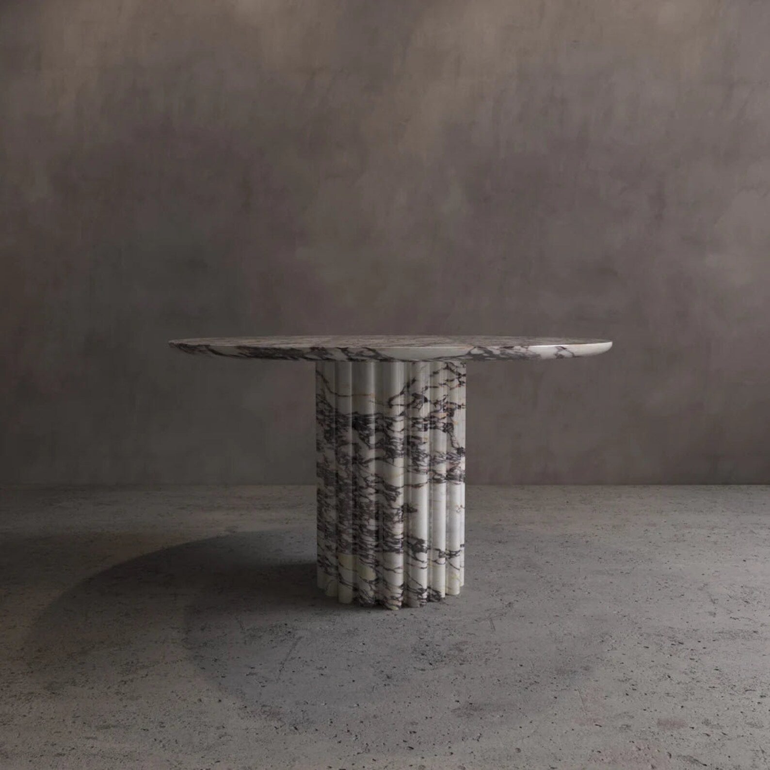 Palermo round marble dining table with sculptural fluted marble pedestal and natural veining by Eden Stone Designs