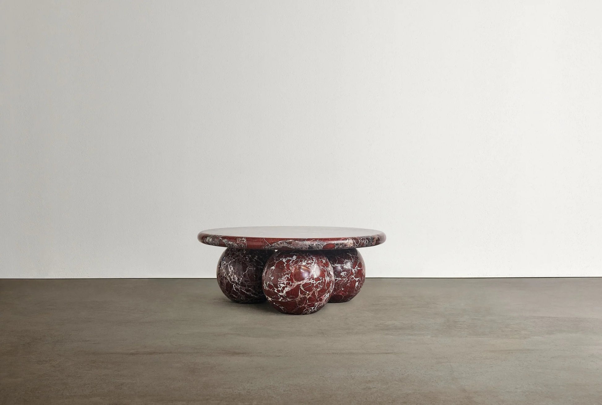 Piccolo Rosso Levanto marble coffee table with sculptural sphere base