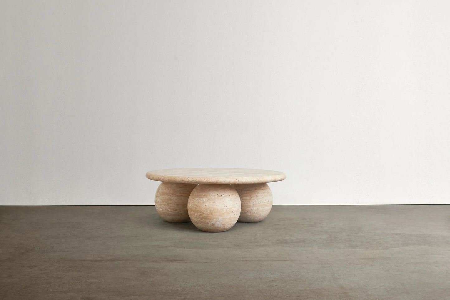 Piccolo travertine marble coffee table with sculptural sphere base