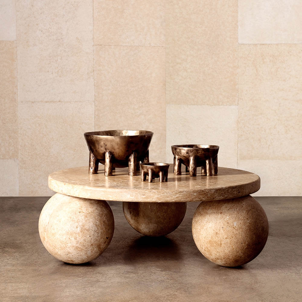 Styled Piccolo travertine coffee table with sculptural sphere base