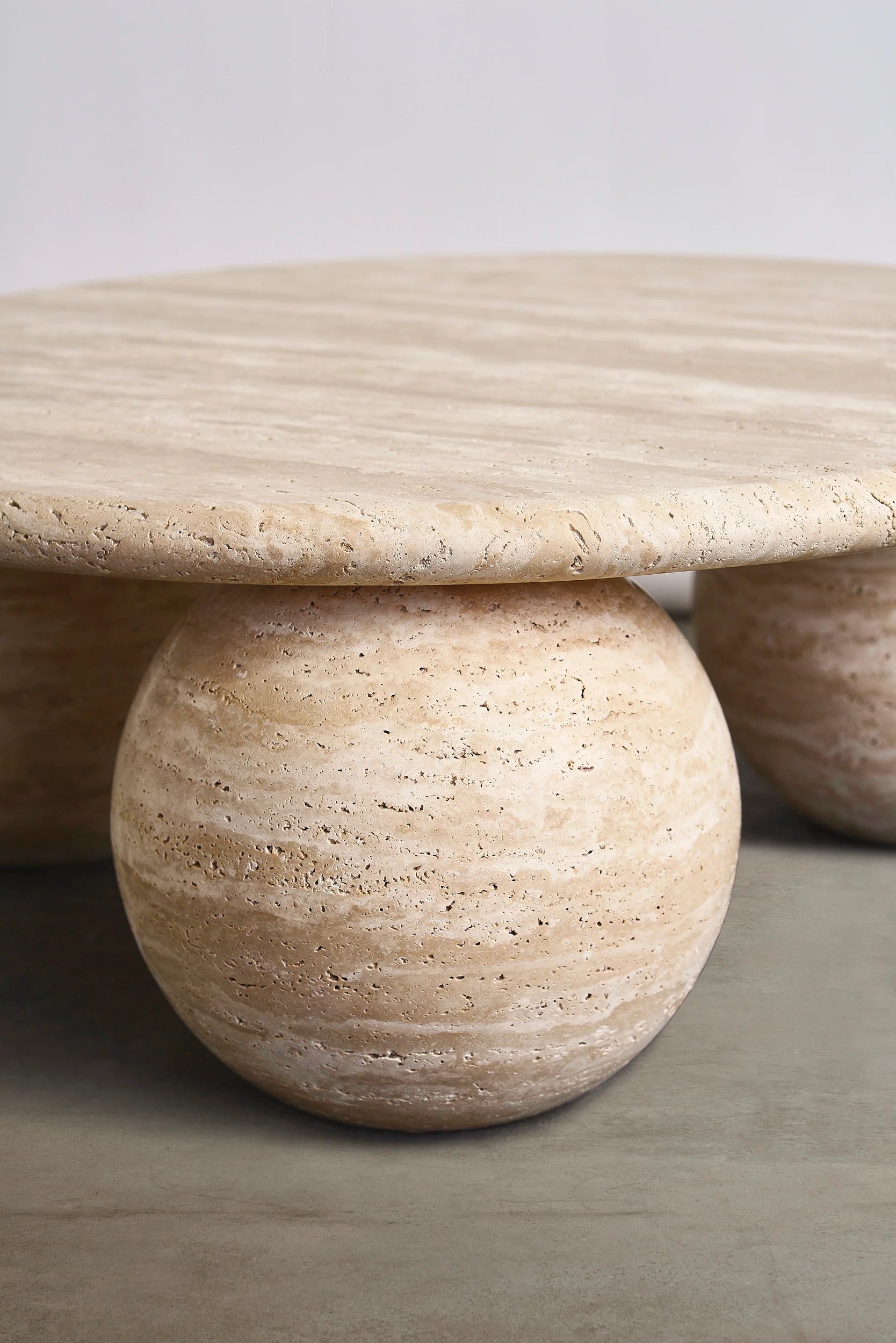 Piccolo travertine marble coffee table sculptural sphere base detail
