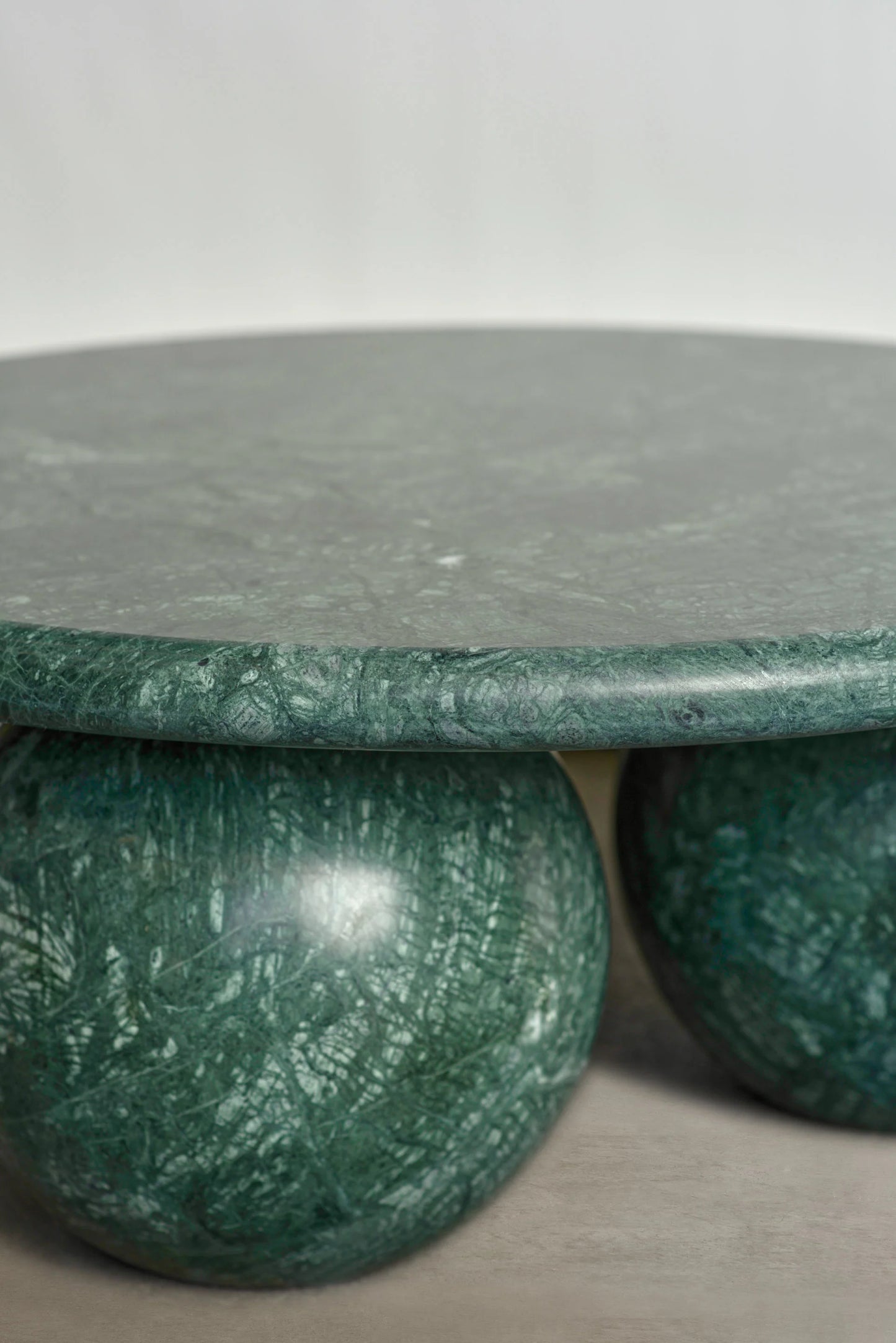 Detail of Verde Alpi marble Piccolo coffee table with sculptural sphere base