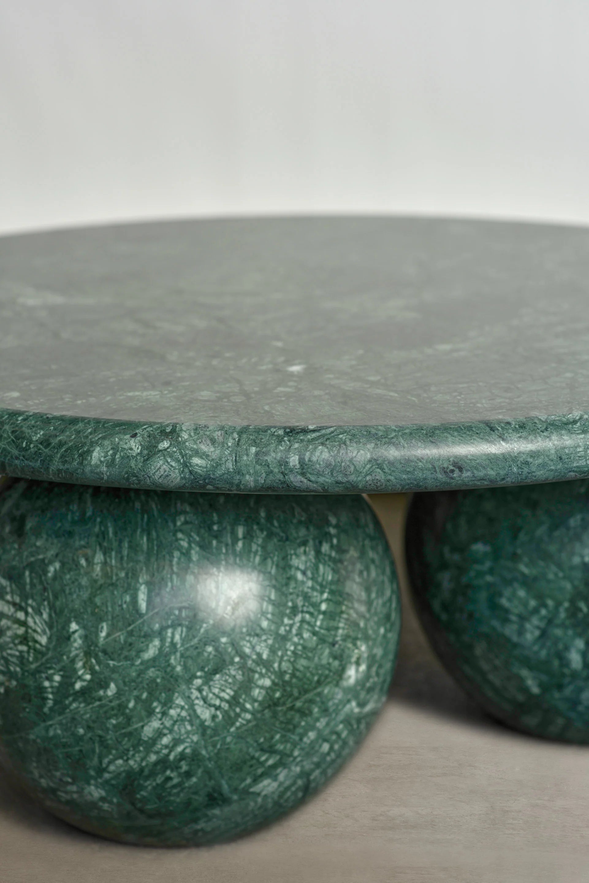 Detail of Verde Alpi marble Piccolo coffee table with sculptural sphere base