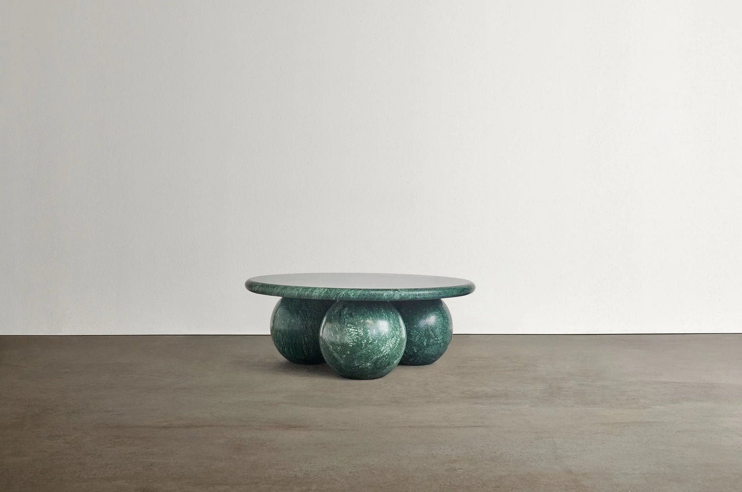 Piccolo Verde Alpi marble coffee table with sculptural sphere base