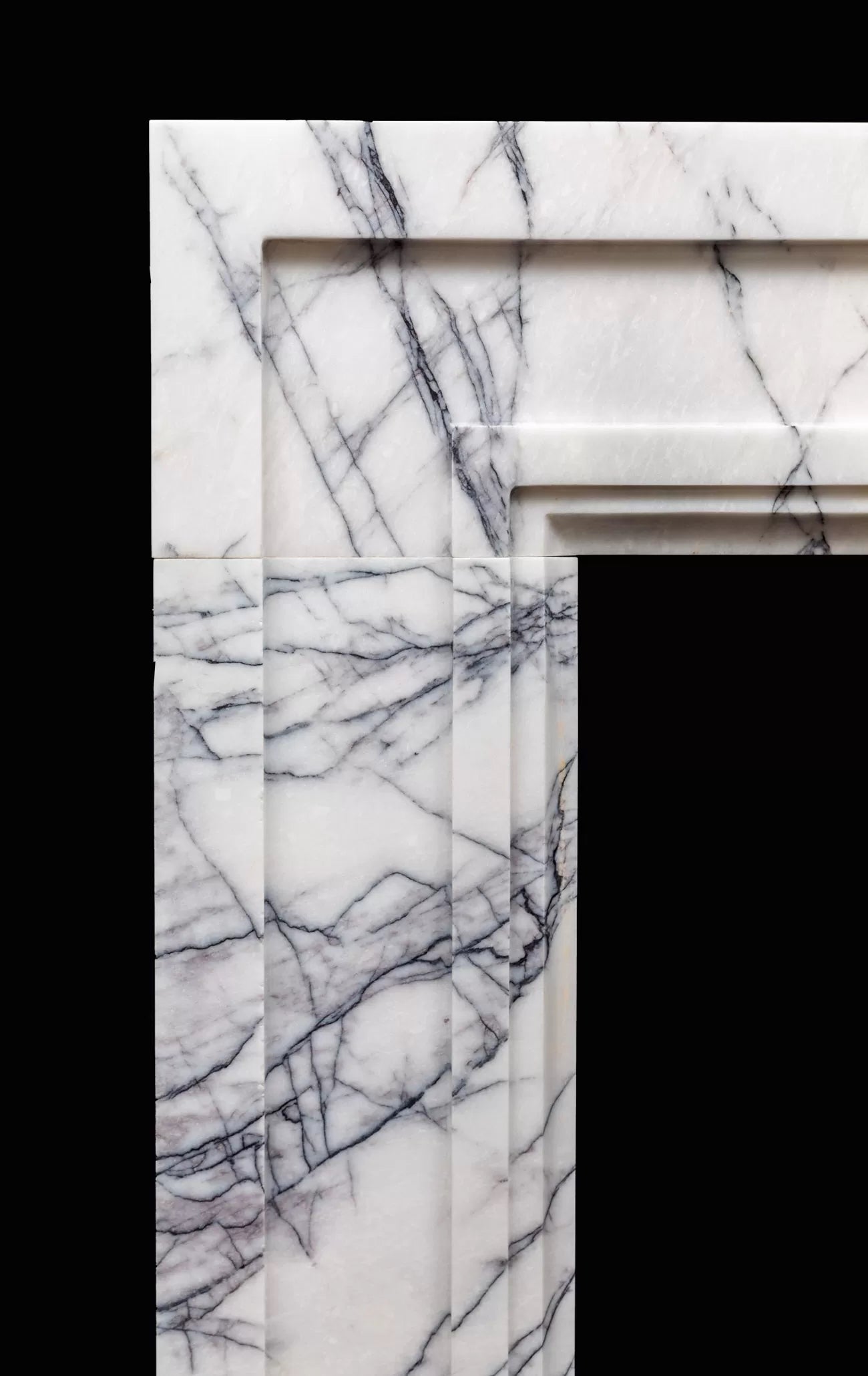 Detail of Tivoli Carrara marble fireplace surround natural veining Eden Stone Designs