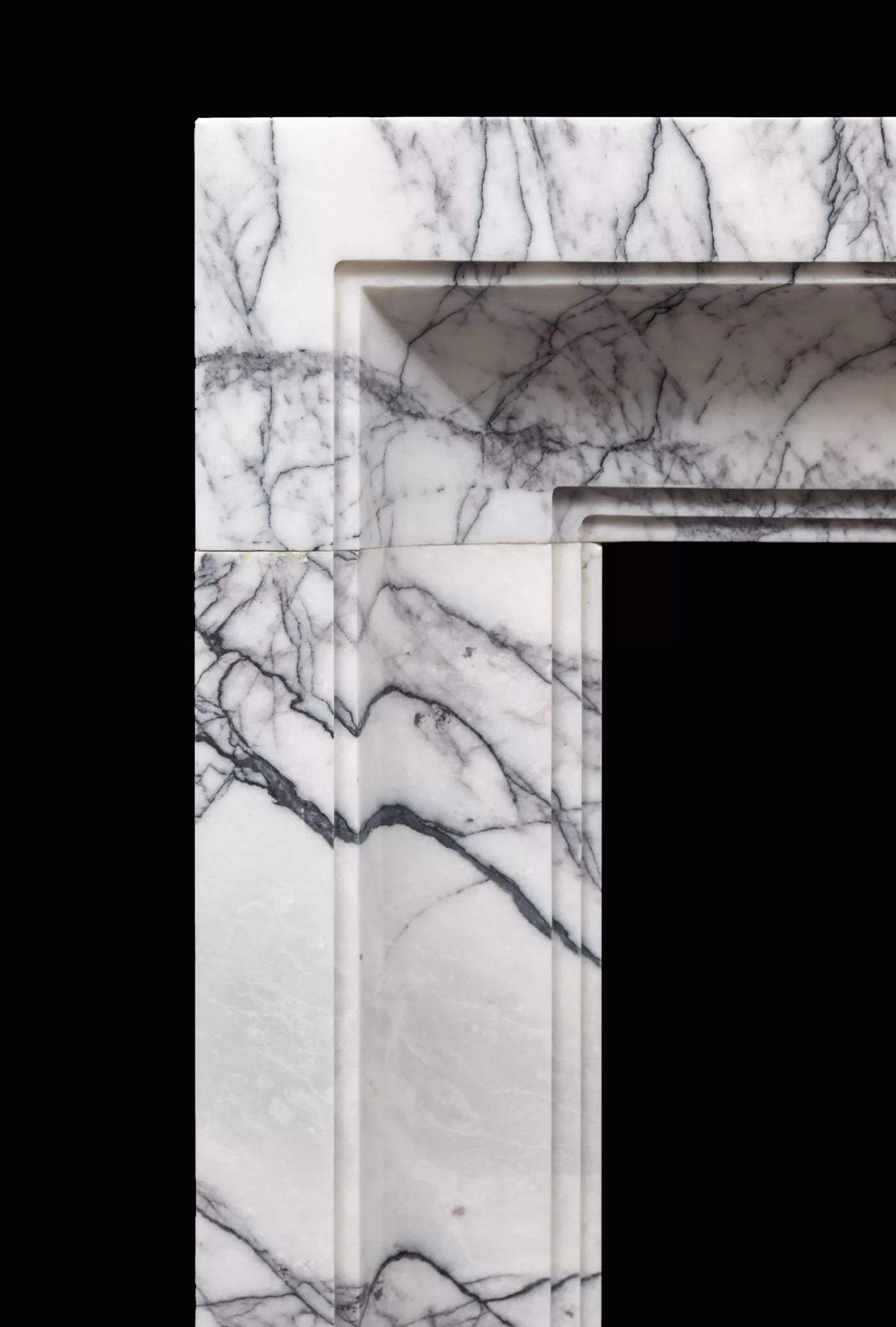 Detail of Tivoli Carrara marble fireplace surround natural veining Eden Stone Designs