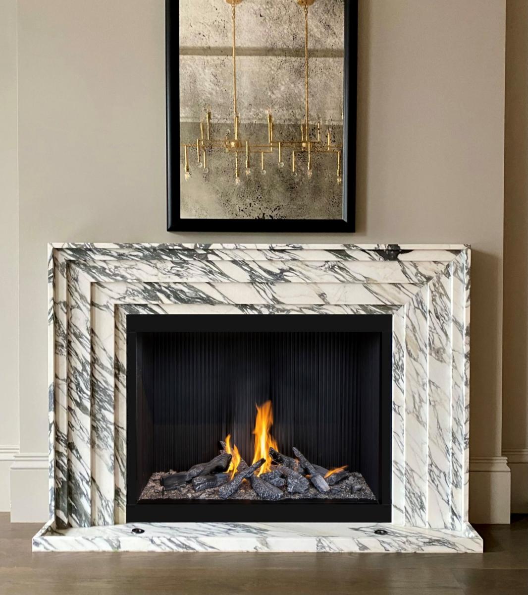 Tivoli Carrara marble fireplace surround with fire luxury interior Eden Stone Designs