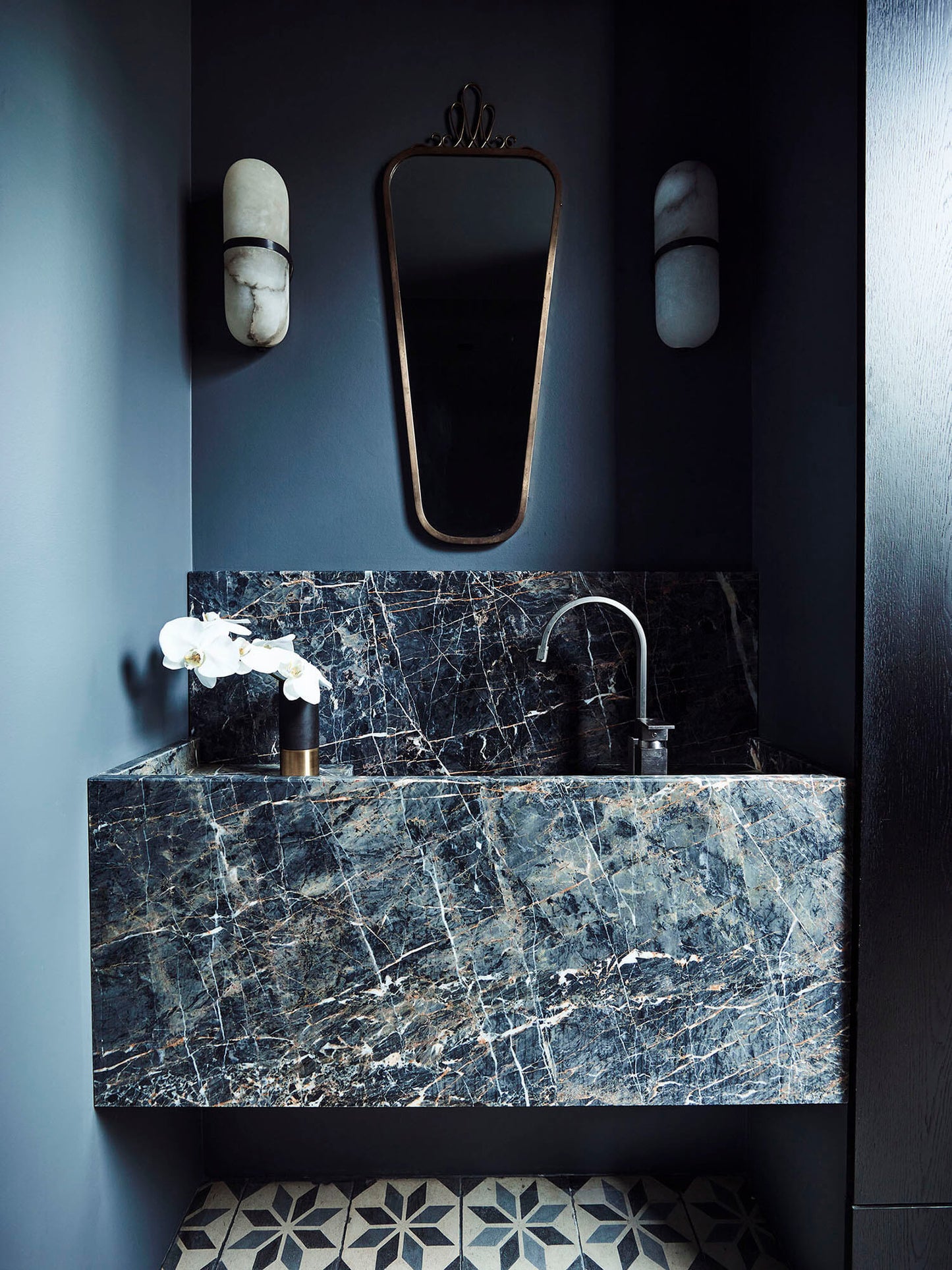 Toscana marble sink in dark natural stone with dramatic veining in a modern luxury bathroom interior