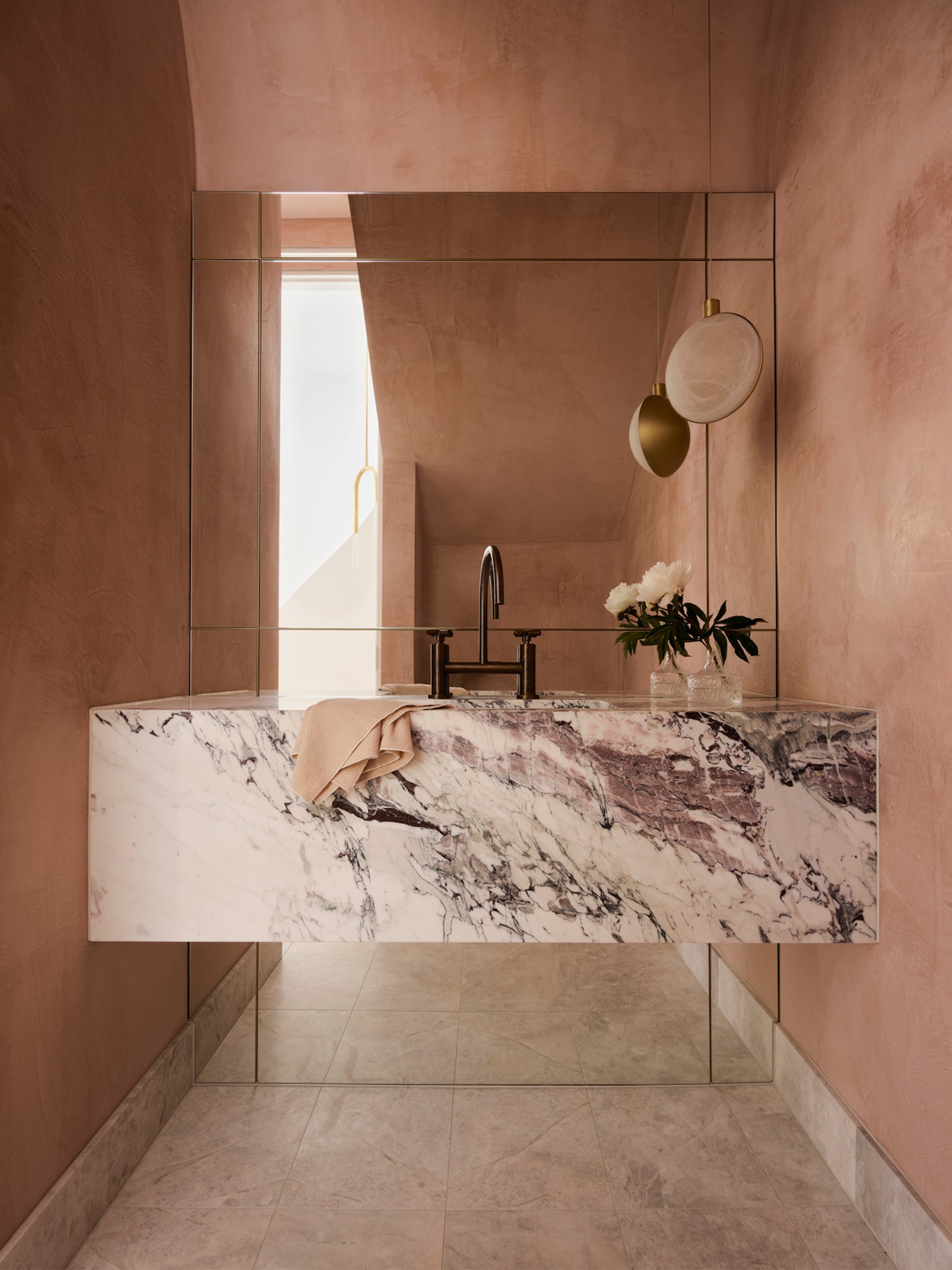 Toscana marble sink in warm pink bathroom with natural stone basin, mirror and contemporary faucet design