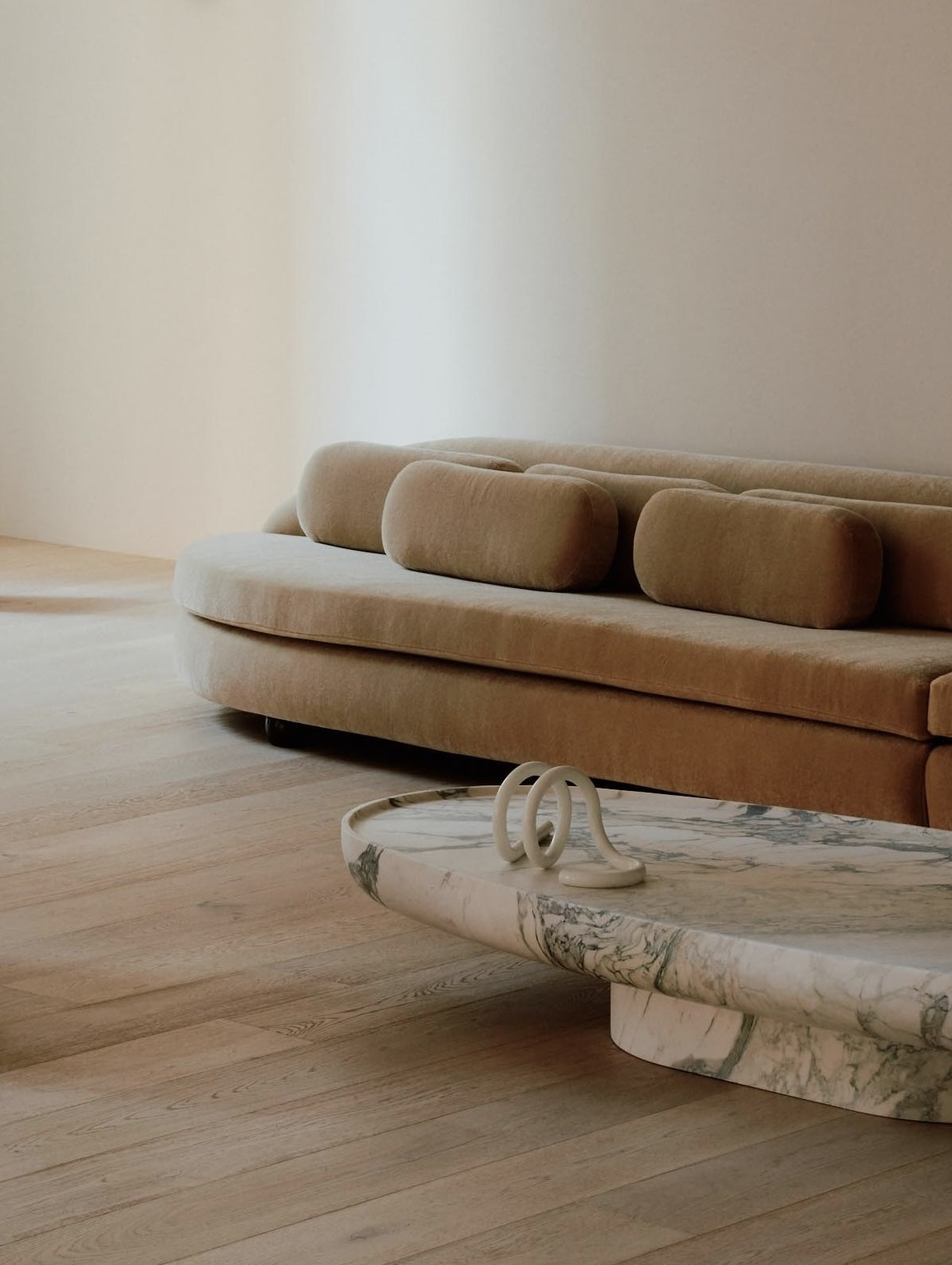 Trento marble coffee table by Eden Stone Designs styled in a modern living room with sculptural sofa