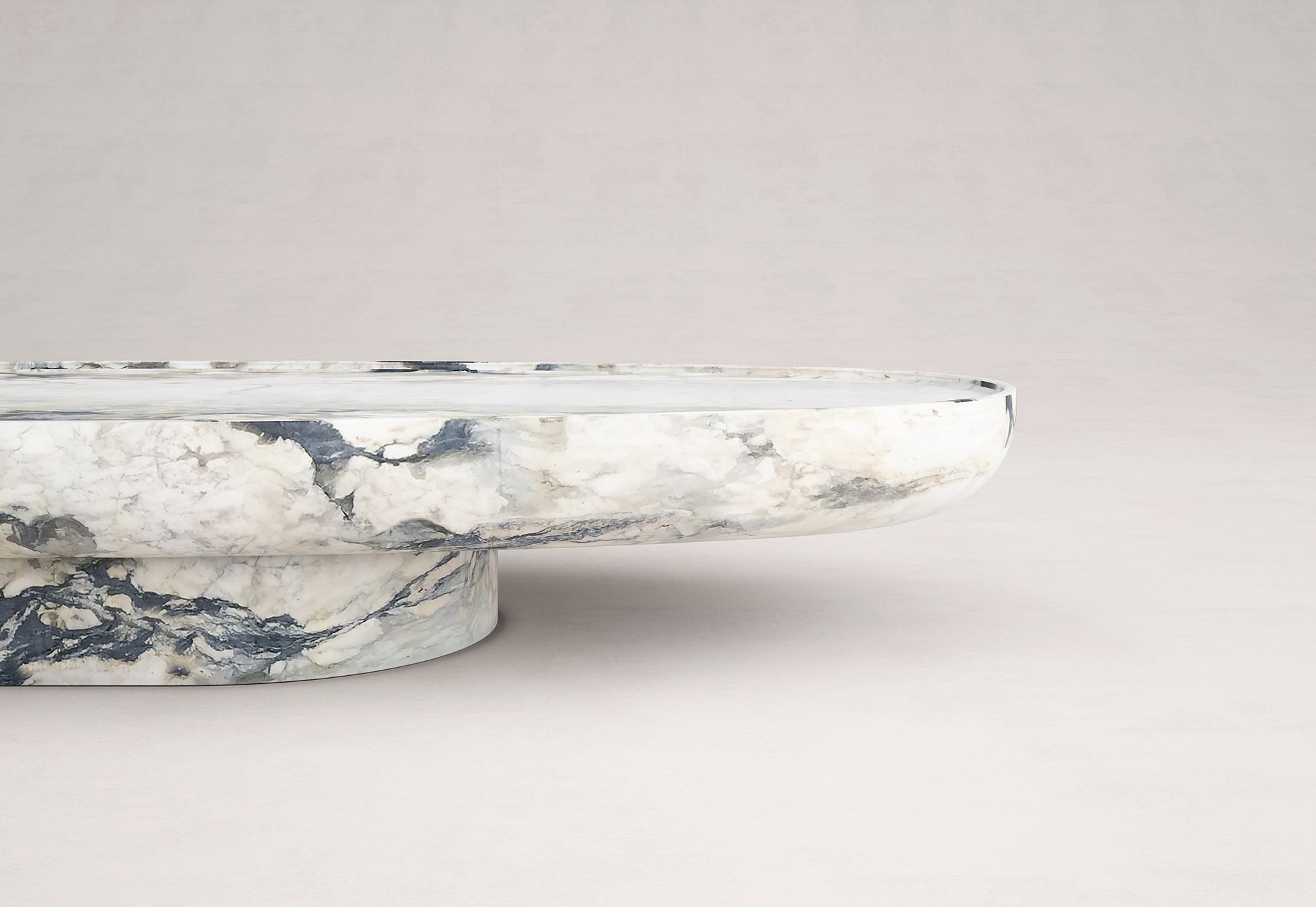 Trento marble coffee table side profile by Eden Stone Designs showcasing sculptural oval stone design