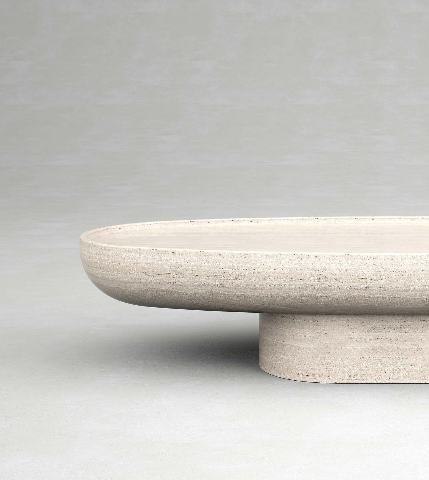 Trento travertine oval coffee table by Eden Stone Designs with sculptural pedestal base and natural stone surface
