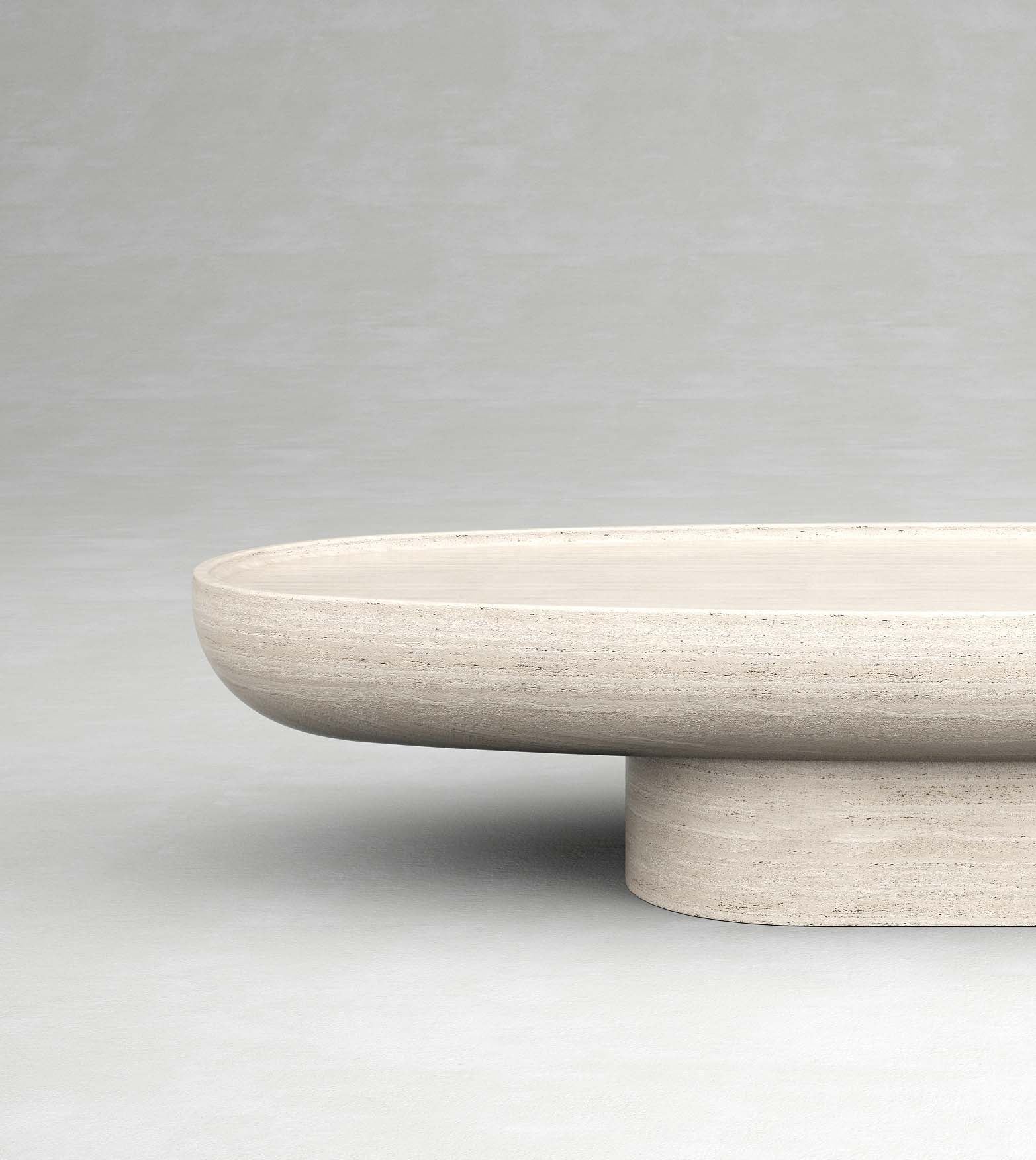 Trento travertine oval coffee table by Eden Stone Designs with sculptural pedestal base and natural stone surface