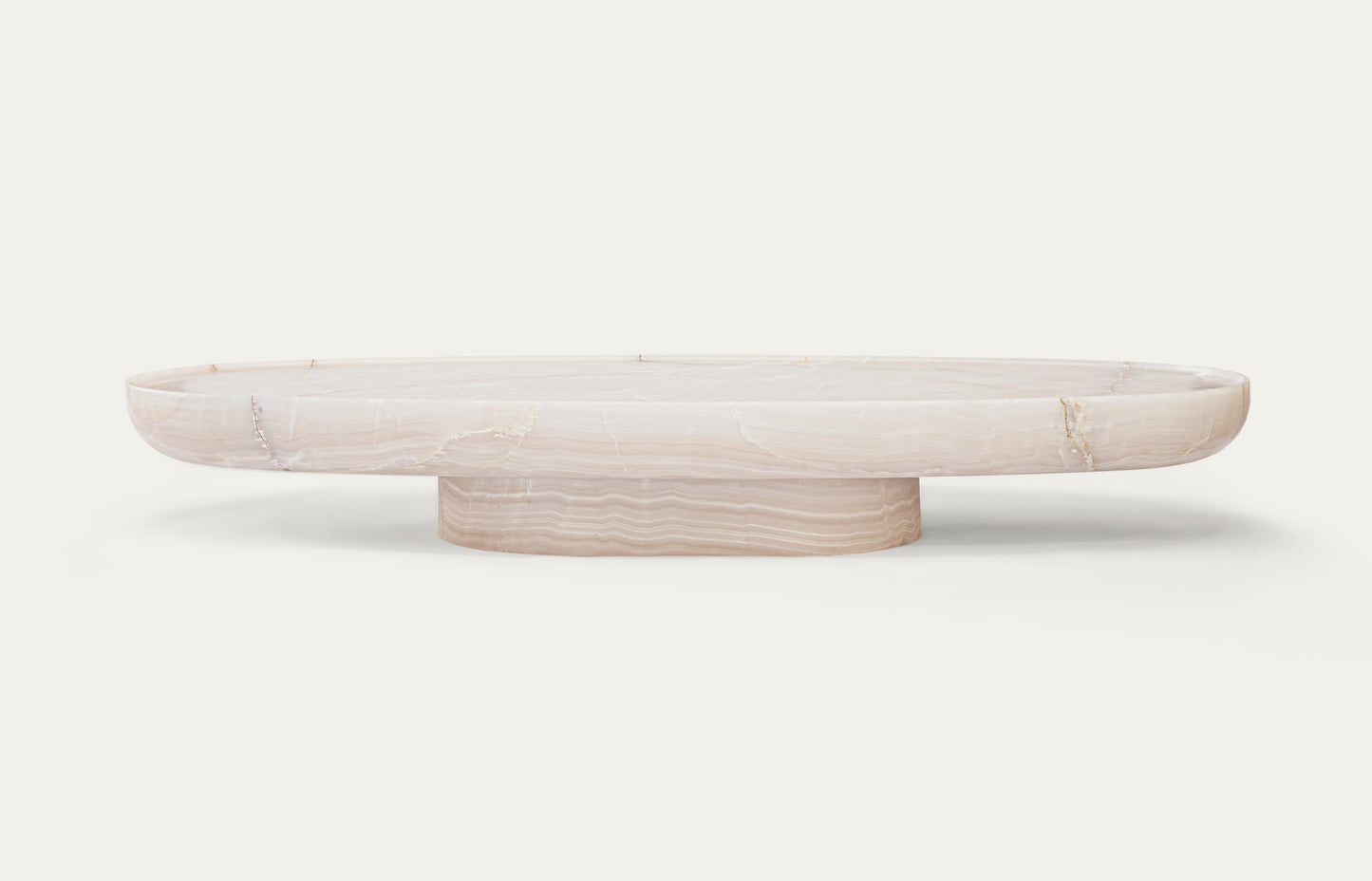 Trento oval onyx marble coffee table by Eden Stone Designs with sculptural base and polished natural stone surface