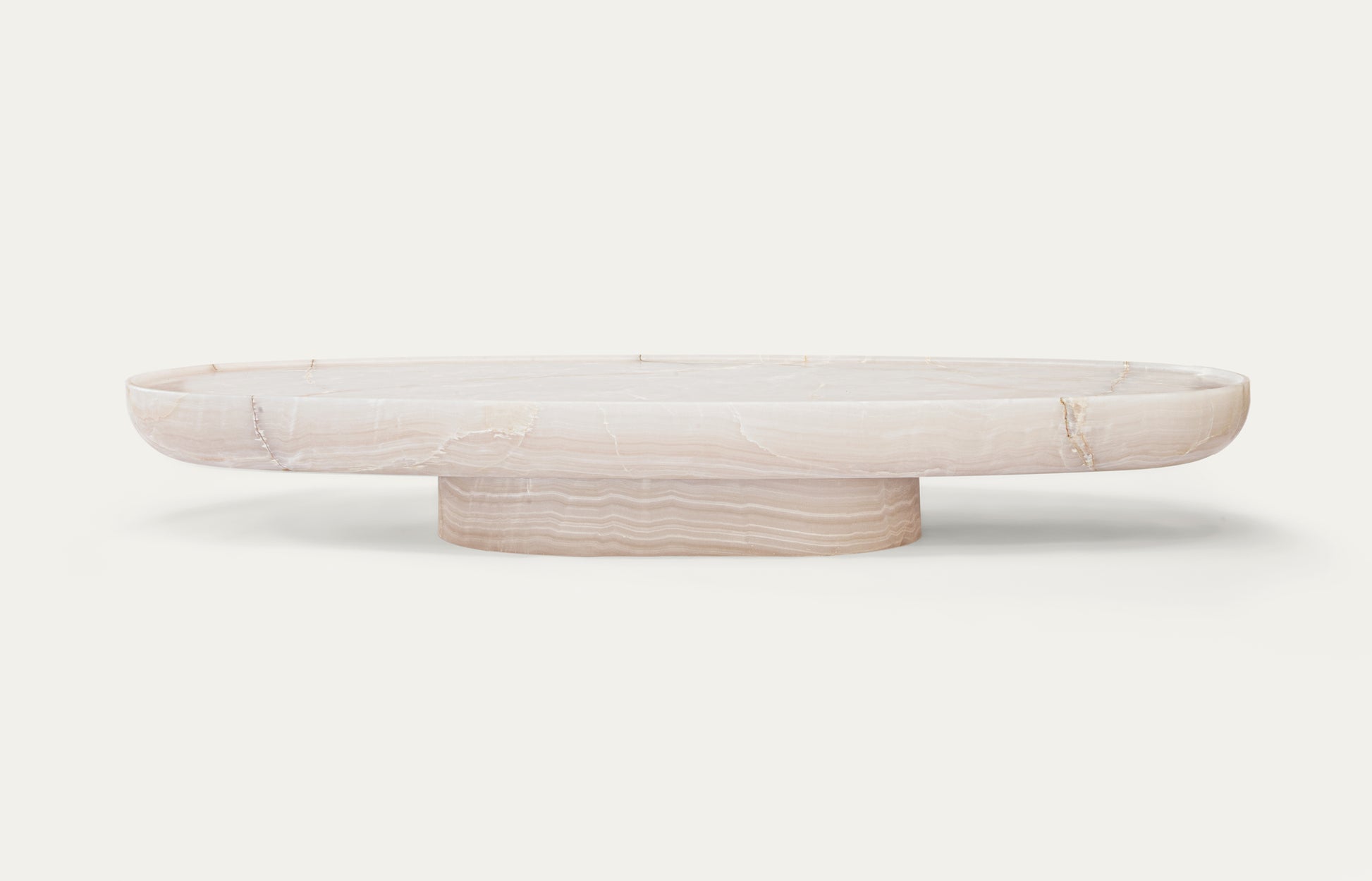 Trento oval onyx marble coffee table by Eden Stone Designs with sculptural base and polished natural stone surface