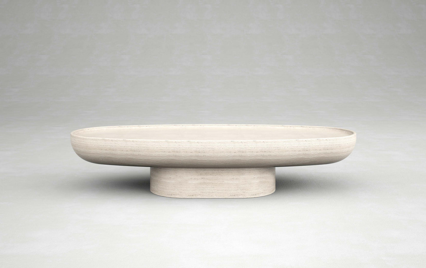 Trento travertine oval coffee table by Eden Stone Designs with sculptural pedestal base and natural stone surface