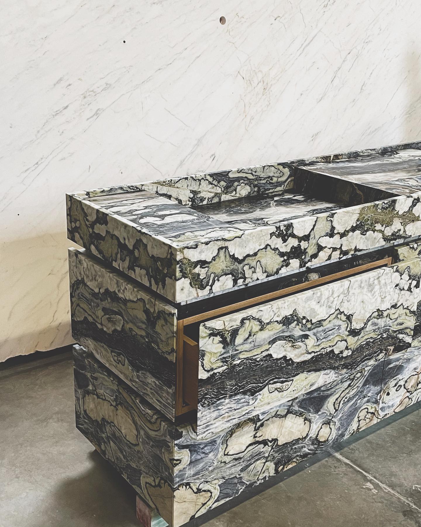 Statement marble vanity with bold natural veining and integrated sink in luxury bathroom design